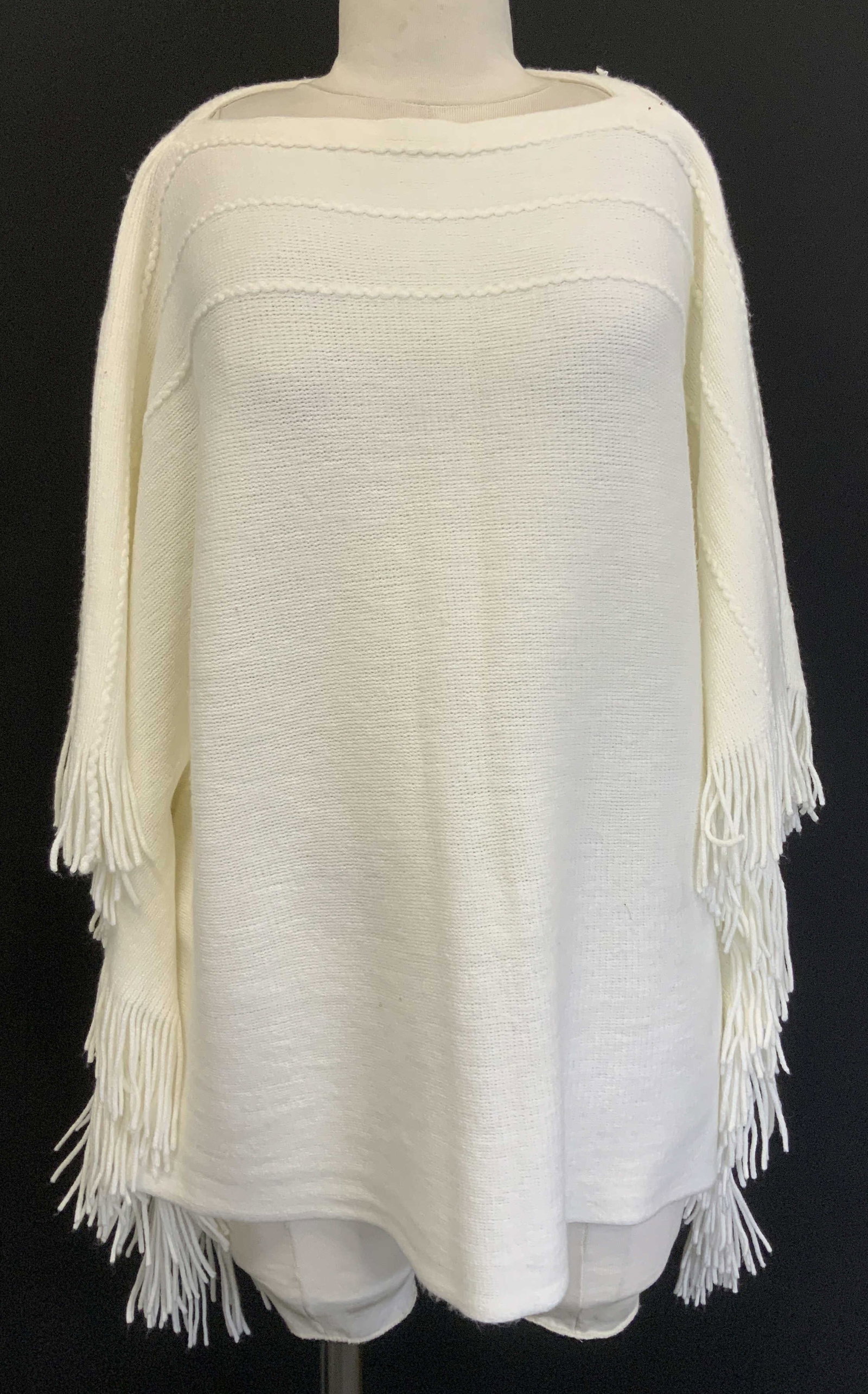 Layers By Lizden White Acrylic Poncho: 100% acrylic. White poncho features a boat neckline & long fringe ends. Signed & marked. Reads, Layers by Lizden. Missy One Size. Surface wear consistent to age, use & exposure. Layers by Lizden white