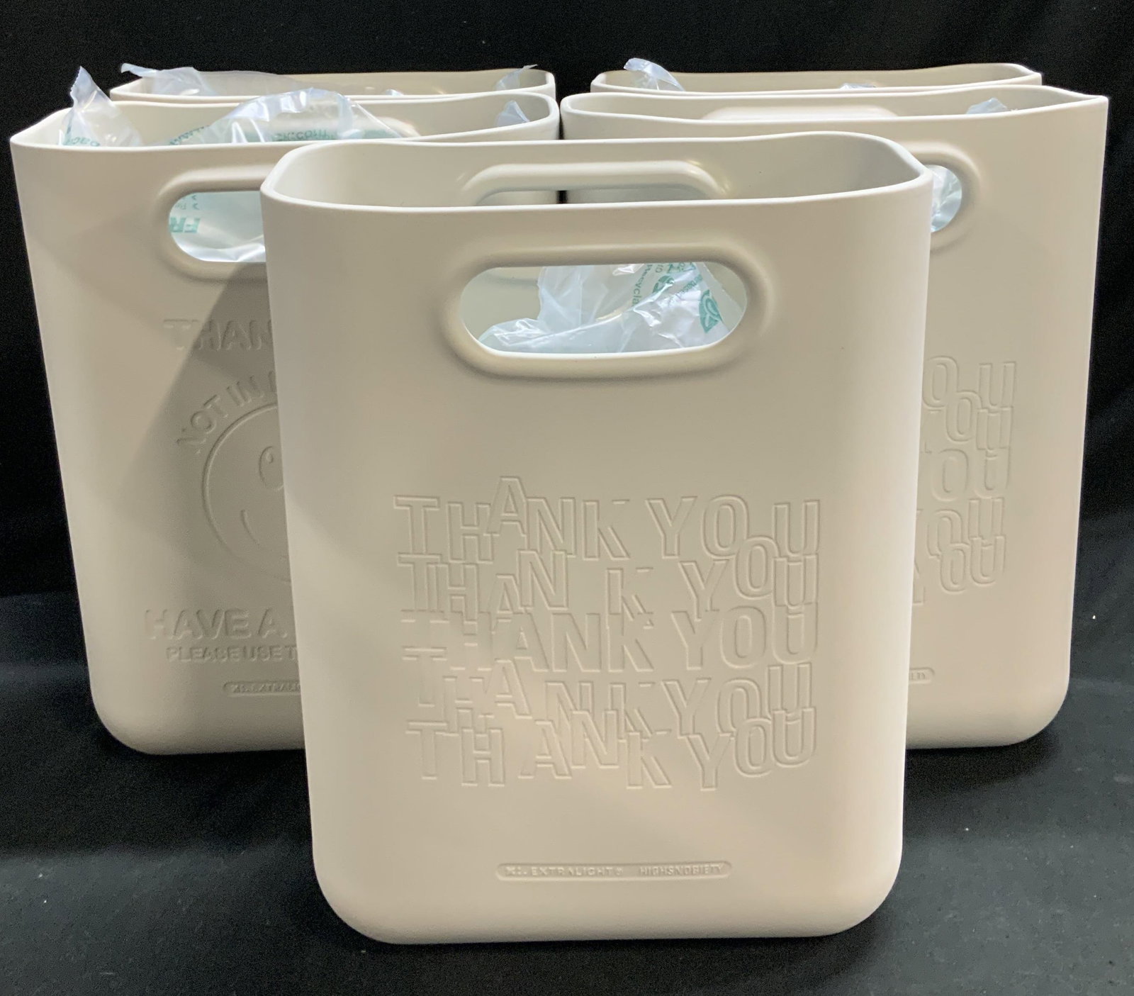 Lot 5 Extralight X Highsnobiety Thank You Bags: Lot includes, 5 EXTRALIGHT x Highsnobiety limited edition bag. Bag reads, Thank You! Not In New York. Have A Nice Day! Features a smiley face. Grey finish. Property of 69th Floor Hudson Yard Estate, M