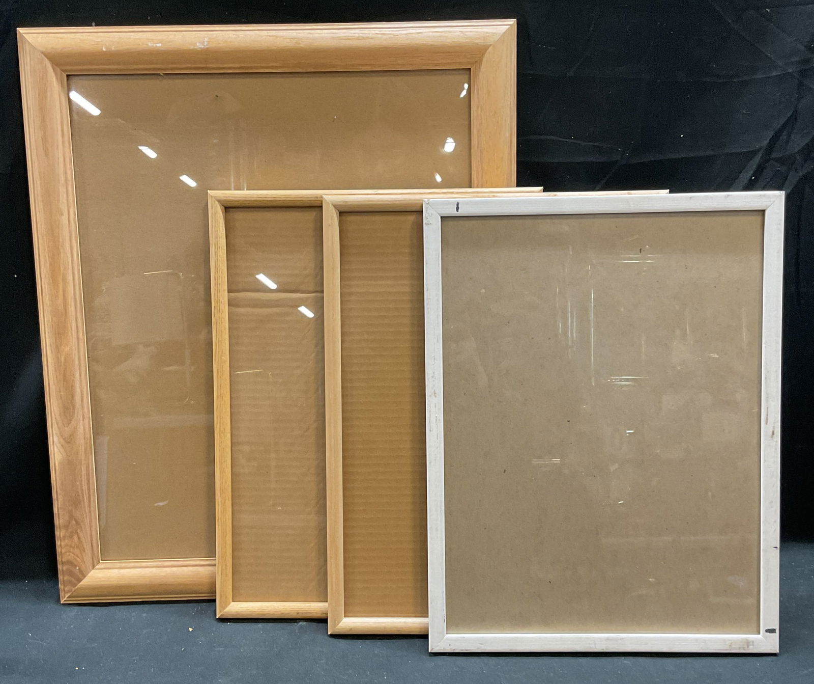 Lot 4 Tan & White Wood Picture Art Frames: Lot of 4 natural tan toned and painted white wood picture or art frames. Larger frame measures approx 23 x 19 inches. Smaller frames approx 13 x 17 inches. All frames have some wear consistent with ex