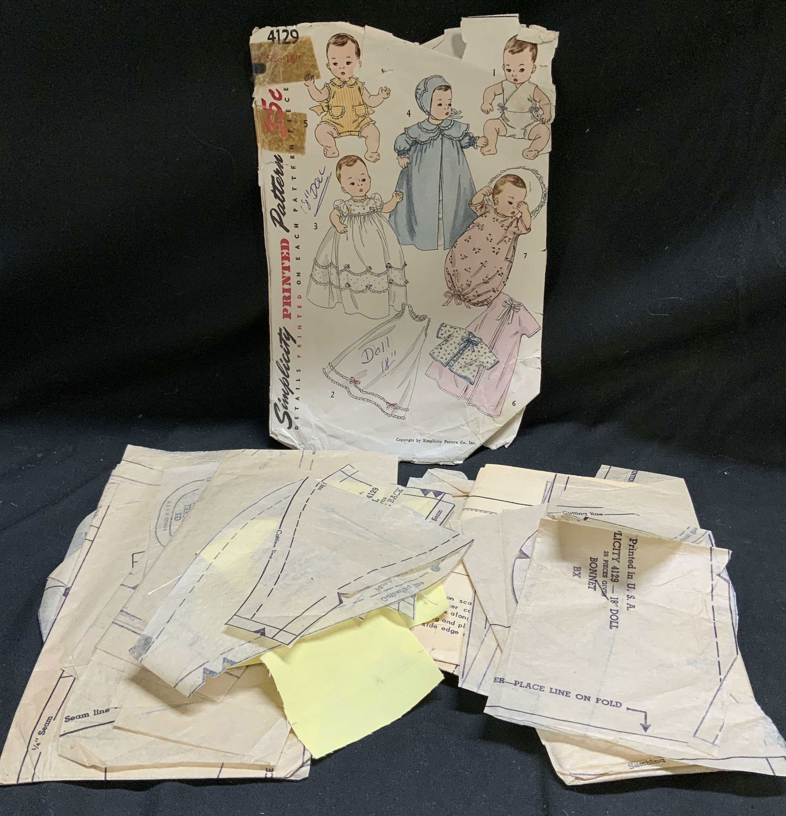 Vntg Simplicity Printed Sewing Patterns Size 18in: Vintage Simplicity printed sewing pattern for an 18 inch baby doll layette 4129. Patterns includes instructions and templates for creating various items of doll clothing, as illustrated by the drawing