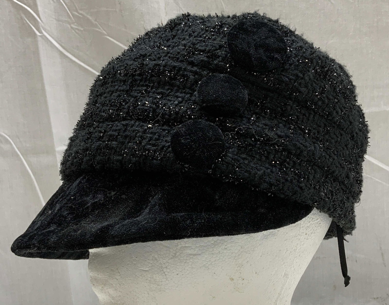 Grace Hats Black Visor Beanie Style JAPAN: Hat is 100% polyester & features a short curved visor. Decorative black circle accents on side & metallic/sparkly finish. Signed & marked. Reads, GRACE HATS. Designed in Japan. Surface wear consistent