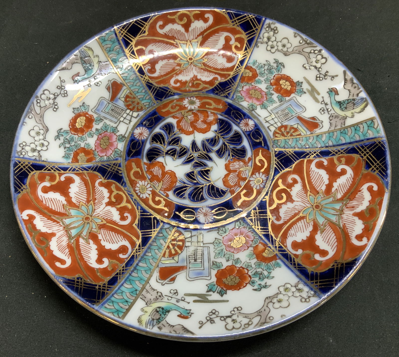 Vtg Japanese Imari Hand Painted Porc Plate: Japanese Imari porcelain plate featuring a traditional hand painted design. Floral & bird motifs. Cobalt blue, gilt, red & green accents. Design is divided into panels. Surface wear consistent to age,