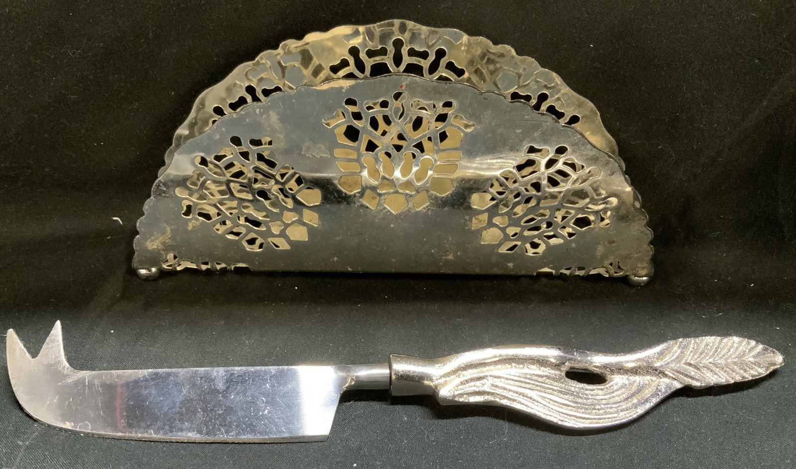 Lot 2 Pierced Napkin Holder & Cheese Knife MAYEL: Lot includes, 1 Mayel pierced ep on steel napkin holder. Also includes, 1 stainless cheese knife. Signed & marked. Reads, MADE IN ENGLAND. MAYELL. EP ON STEEL. Surface wear consistent to age, use & ex