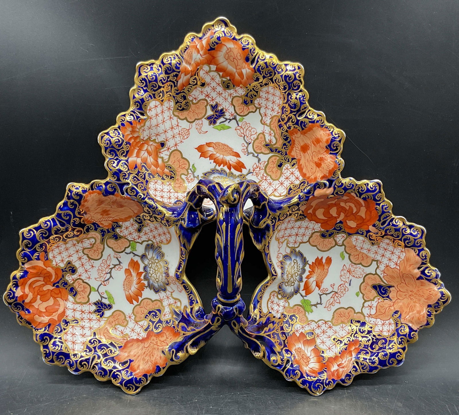 Royal Crown Derby Imari 3Bowl Serving Dish England: Royal Crown Derby Imari pattern fine bone china serving dish. Three scalloped leaf shaped bowls with vine handle. Cobalt blue, red, and gilt decoration with floral motifs. Hand painted. Signed with ba