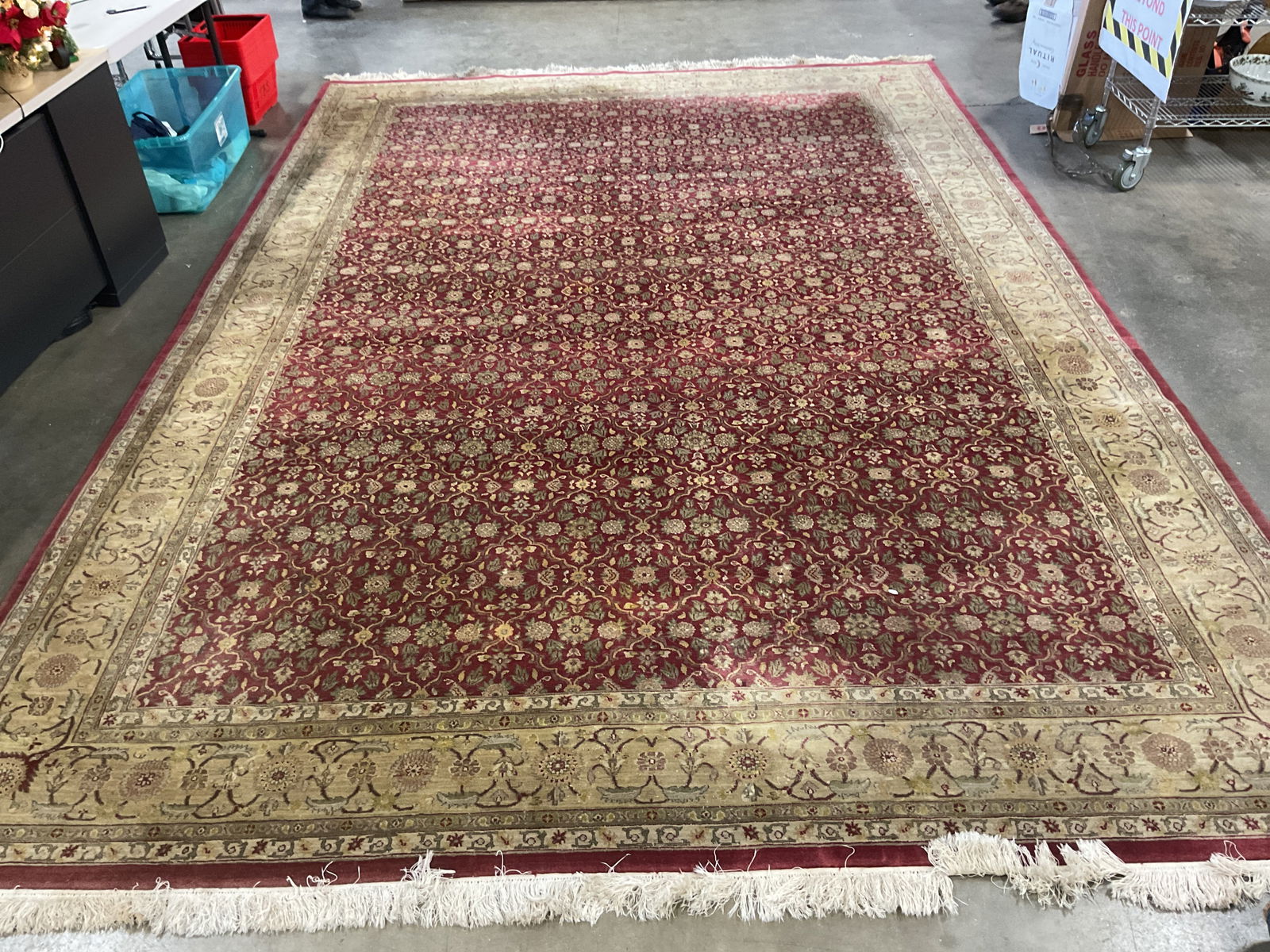 Red Floral Wool Room Size Area Rug: Red floral pattern wool area rug with fringe. Intricate geometric border design. Measures approx 171 x 118 inches. Wear including discoloration. Rug, wool rug, area rug, red rug, floral rug, home deco