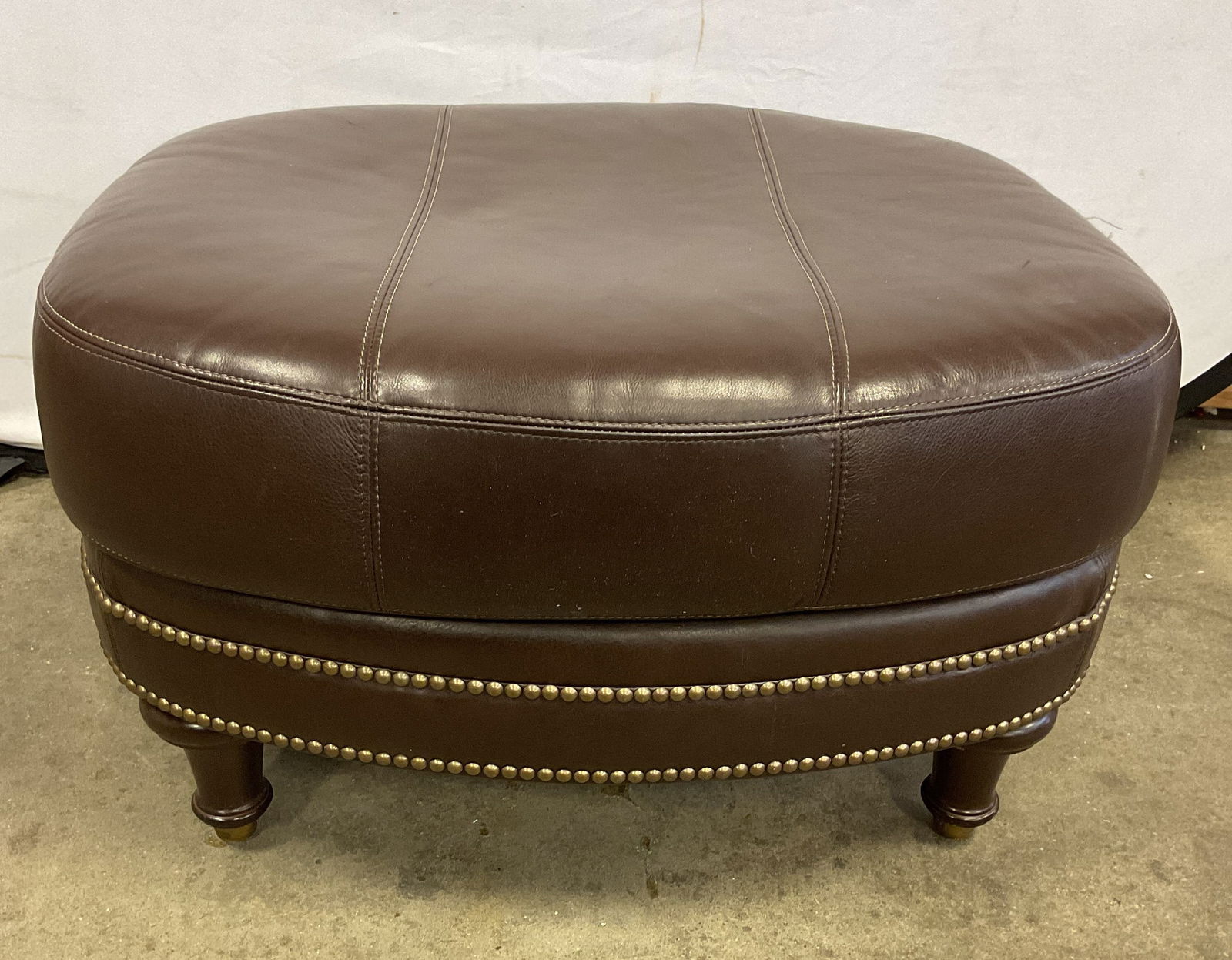 Chaddock Surrey Brown Leather Nailhead Ottoman: Chaddock Living leather ottoman. Surrey pattern. Brown leather with nailhead trim. Bloomingdales label on underside. Measures approx 29 x 27 x 18 inches. No signature. Some scratching and marks to lea