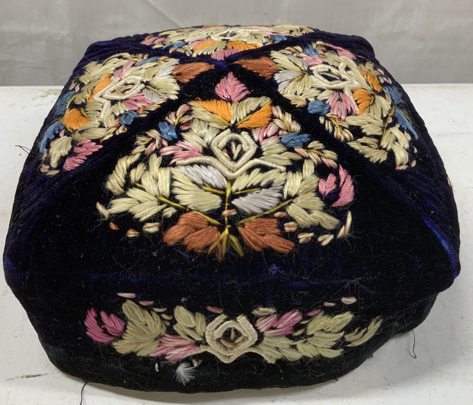 Vtg Hand Embroidery Tubeteika Style Skull Cap: Vintage tubeteika style skull cap features a dark blue velvet fabric with intricate floral embroidery motifs. Shades of orange, blue, pink, white & green. Surface wear consistent to age, use & exposur