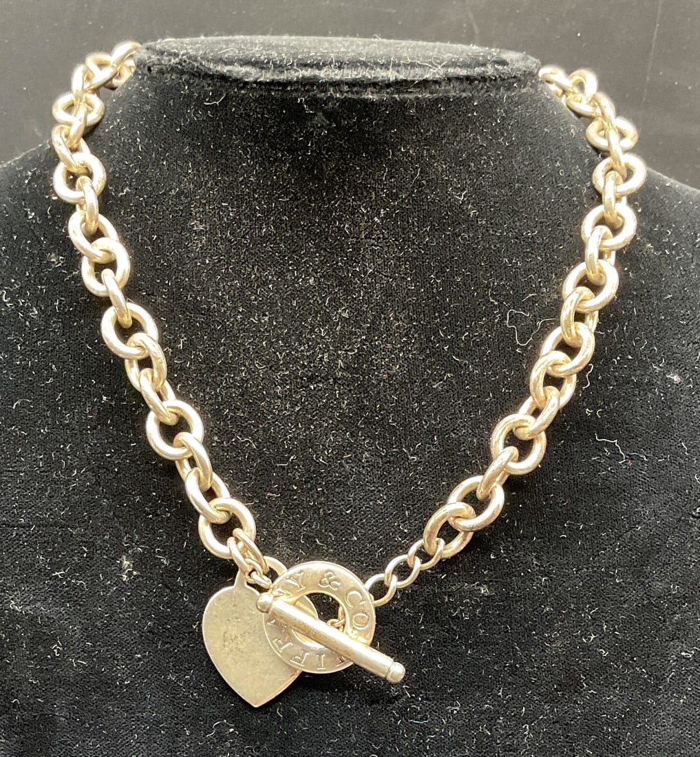 Tiffany & Co Sterling Silver Chain Necklace: Tiffany & Co classic sterling silver chain necklace with heart tag charm pendant. Signed on toggle clasp and pendant. Marked sterling. Drop length approx 7 inches. Total weight 75.4 grams. Some scratc