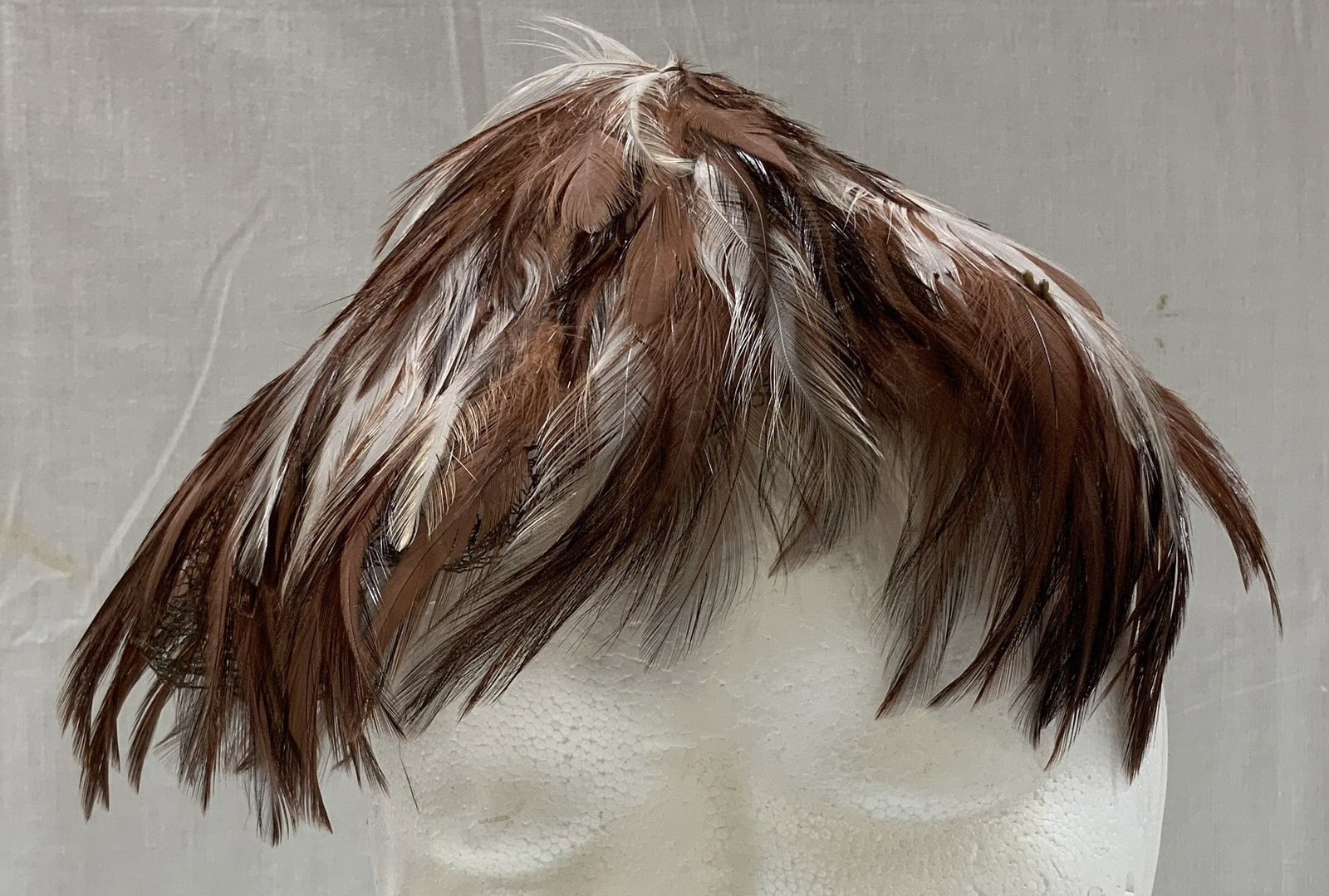 Vntg Union Made Feathered Headpiece USA: Vintage headpiece features brown & white feathers with a black netting trim. Possible fascinator. Comes with white box. Signed & marked. Reads, Union Made. KW900594. USA. Surface wear consistent to ag