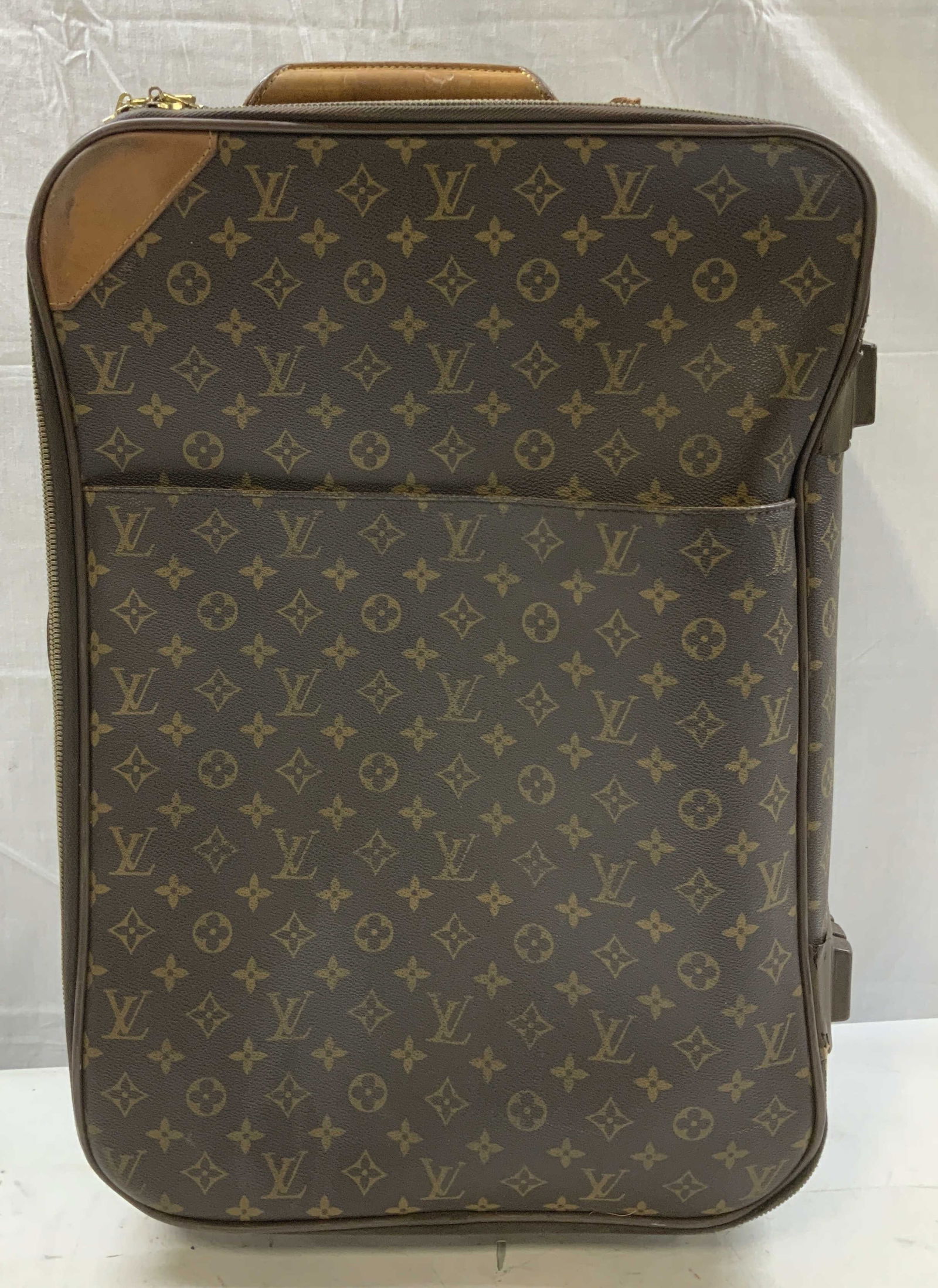 Louis Vuitton Pegase Monogram Suitcase FRANCE: Louis Vuitton Pegase rolling suitcase in monogram canvas with leather trim. Features a large front pocket. Leather handles on sides & top. Interior straps. Signed & marked. Reads, Louis Vuitton. PARIS