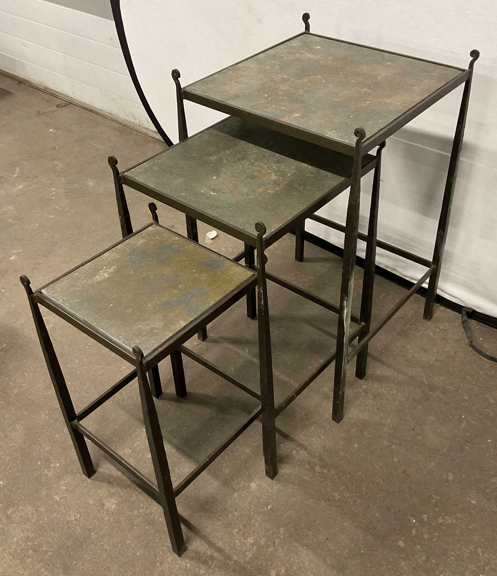 Set 3 Iron & Slate Stone Nesting Accent Tables: Set of 3 matching iron frame nesting tables with slate style stone tops. Curved finials. Largest table measures approx 17 x 17 x 28.5 inches. Some wear including patina and scratching. Iron table, sla
