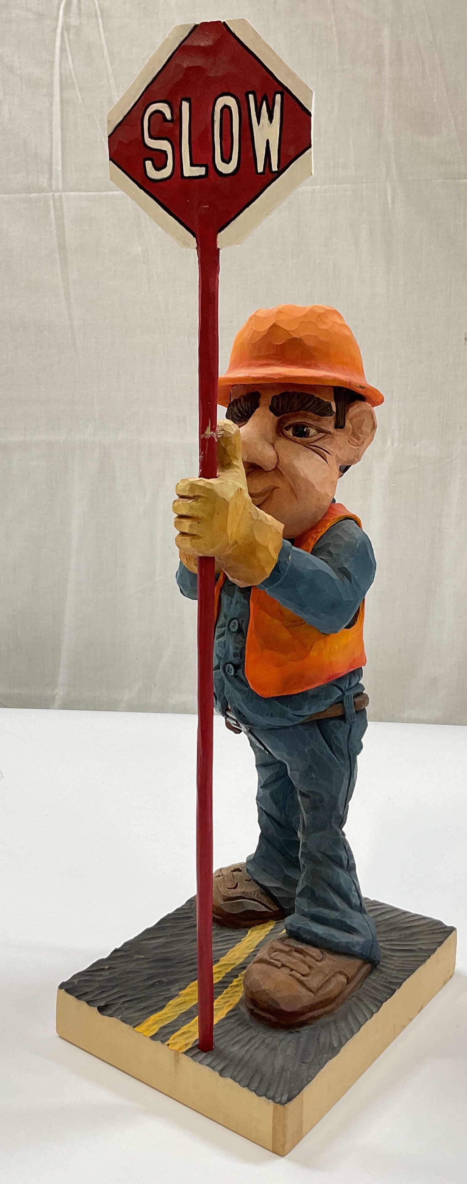 SGND Hand Carved Wood Folk Art Figure 2003: Signed hand carved wood folk art figure. Signed on underside, reads as follows Dennis Thornton 2003. Depicts a hand carved figure of a construction worker. Dressed in construction worker clothing. Col