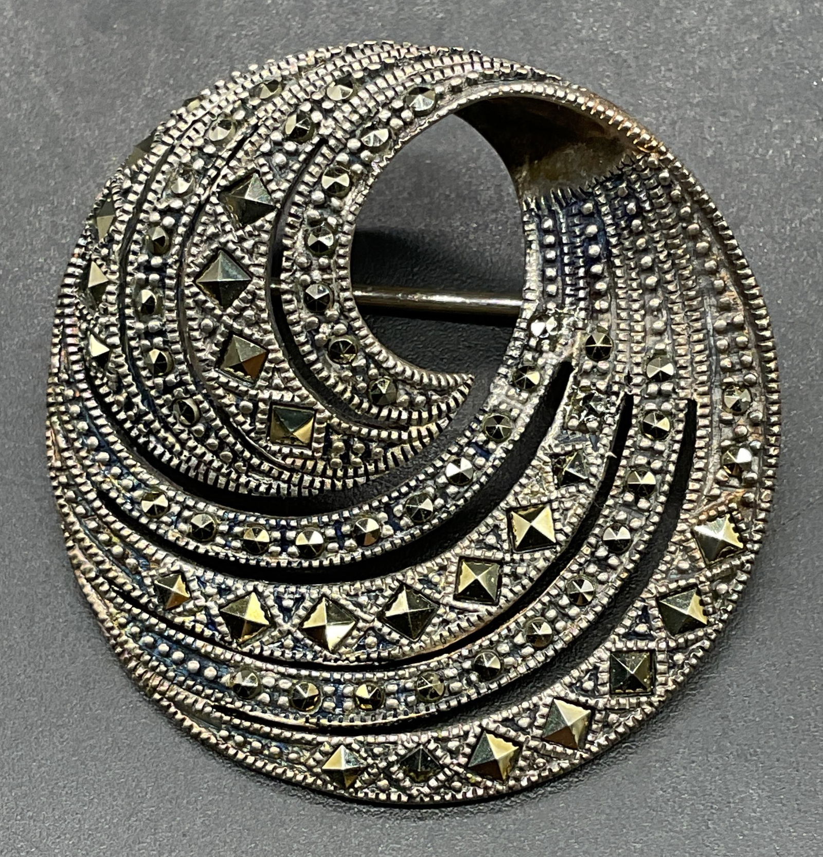 Sterling Silver Marcasite Swirl Circle Brooch: Sterling silver and Marcasite open circle swirl brooch. Measures approx 1.25 inches wide. Total weight 10.6 grams. Marked sterling. Some scratching. Jewelry, estate jewelry, fine jewelry, cocktail jew