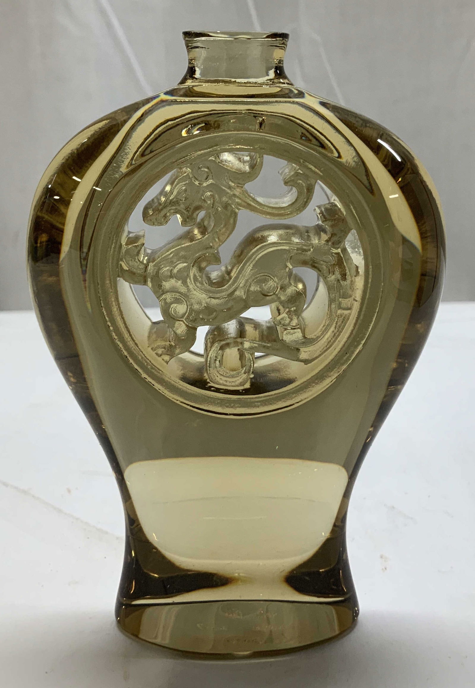 Chinese Tittot Art Glass Dragon Motif Paperweight: Chinese Tittot art glass bottle paperweight featuring an internal carving of a dragon motif. Amber toned. Comes with original box & certificate of authenticity. Signed & marked on underside. Reads, Ti