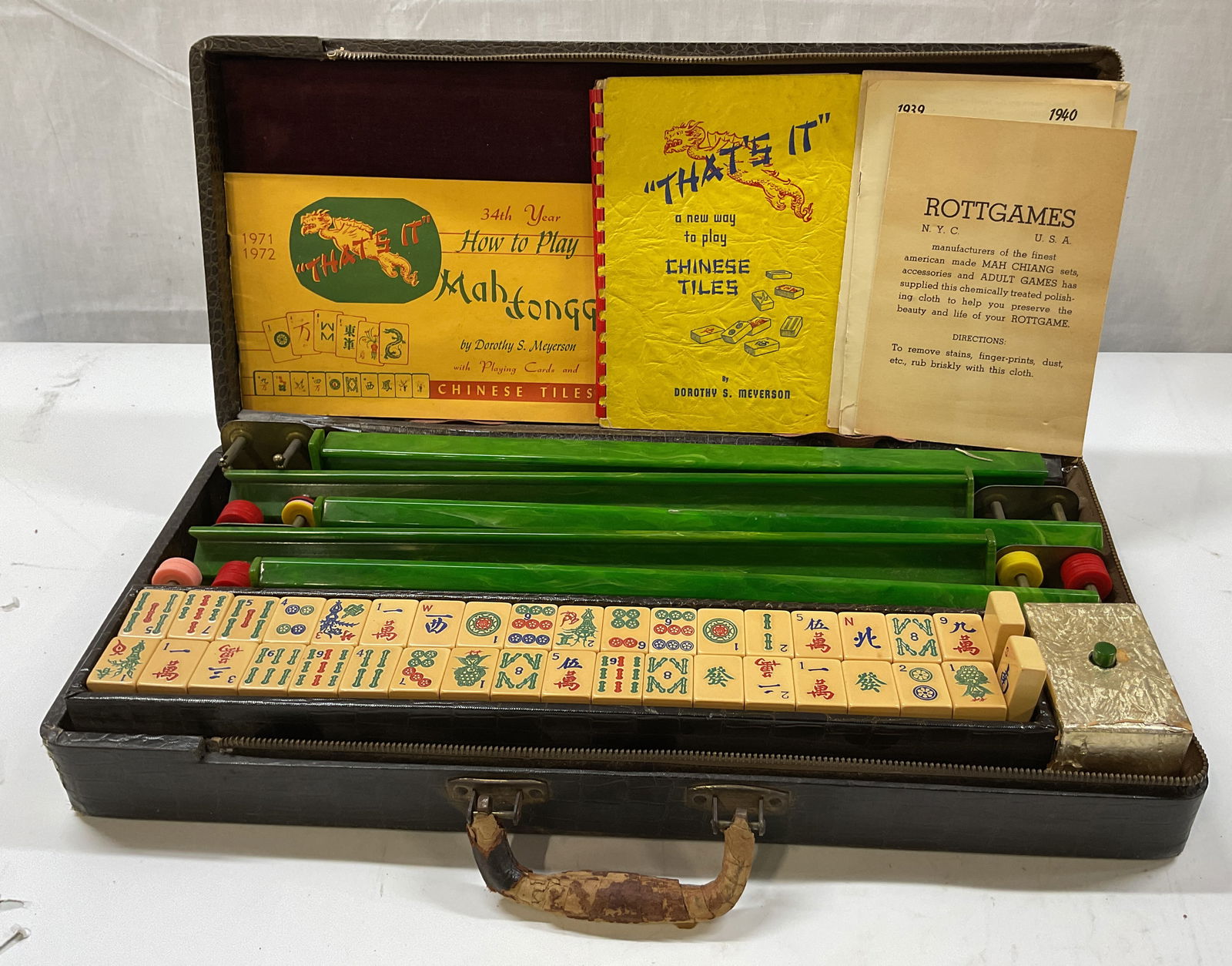 Vintage Mahjongg Chinese Tiles Game W Case & More: Vintage Mahjongg Chinese tiles game. Manufactured by Rottgames, NYC USA. Includes 145 tiles, instructional and informational pamphlets, racks, cleaning cloth, leather zippered case, and scoring chips.
