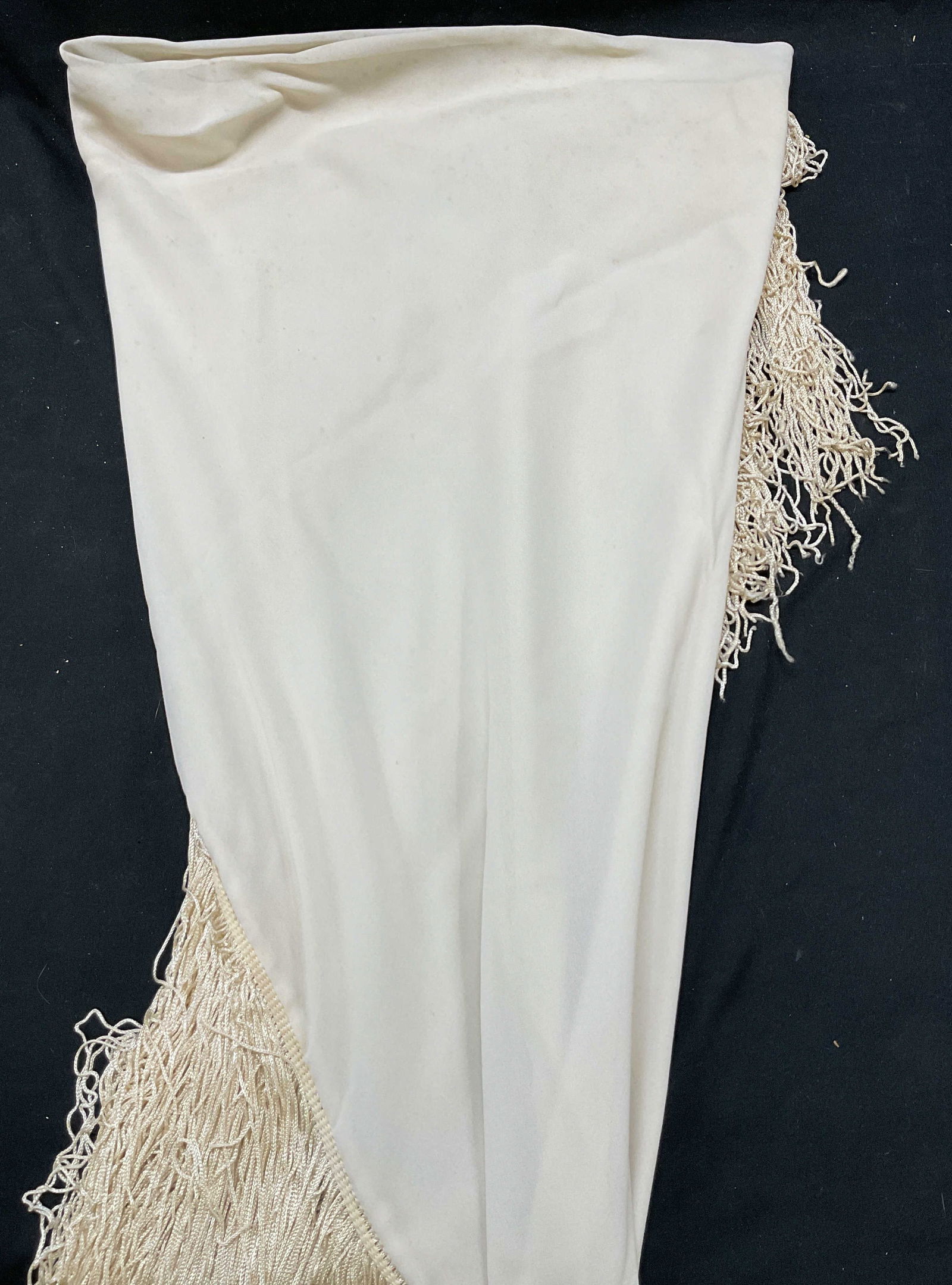 Vintage White Fringed Shawl: Vintage white fringed shawl. Feels like silk. White fringed trim. Measures approx 42 x 56 inches. Some pull to stitching and blemishes observed. Wear consistent with exposure. Property of opera singer