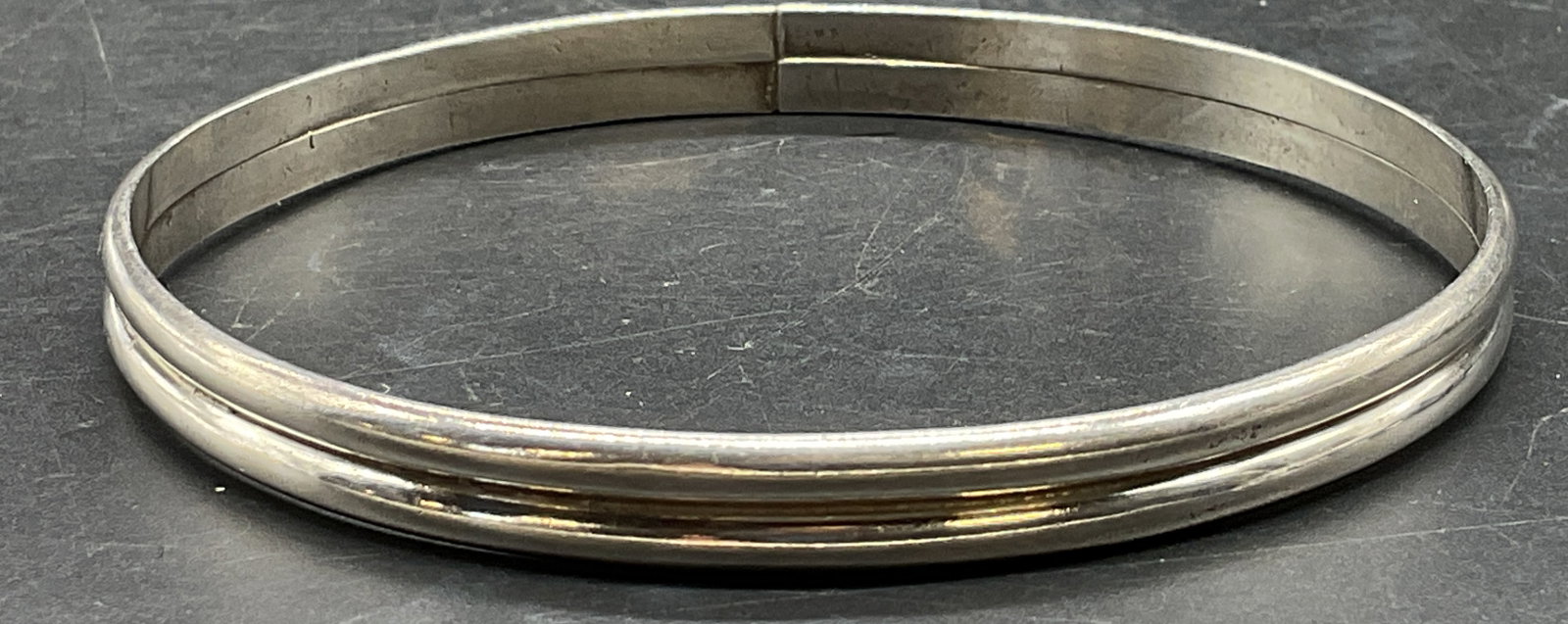 Sterling Silver Stacked Band Bangle Bracelet: Sterling silver stacked band design bangle bracelet. Measures approx 2.5 inches wide. Total weight 17.1 grams. Tests for sterling using acid test. Some scratching. Jewelry, estate jewelry, fine jewelr
