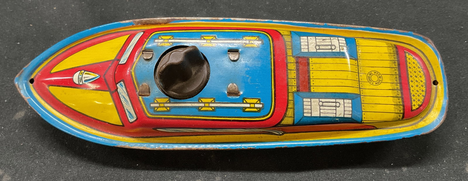 T. Cohn Metal Tin Wind Up Toy Boat USA 1960s: T. Cohn metal tin wind up toy boat. Made in USA. Marked T. Cohn Inc. Made In USA. 1960s toy. Vibrant red, yellow, and blue colors with intricate litho patterns. Designs to look like a boat. Operated b