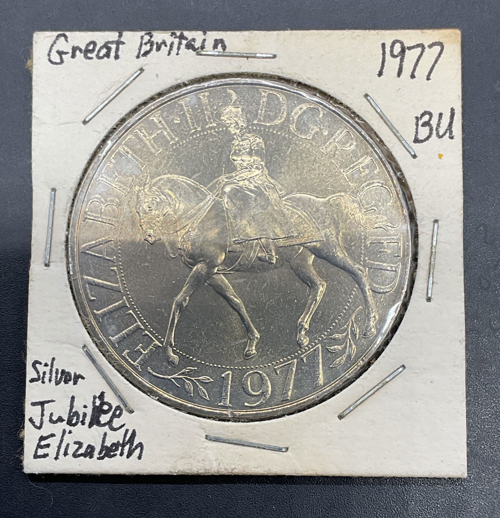 1977 Britain Queen Elizabeth Silver Jubilee Coin: 1977 British Crown coin commemorating the Silver jubilee of Queen Elizabeth II. Obverse features Queen Elizabeth II on horseback, reverse with eagle and crown. Composed of nickel copper alloy. Marked
