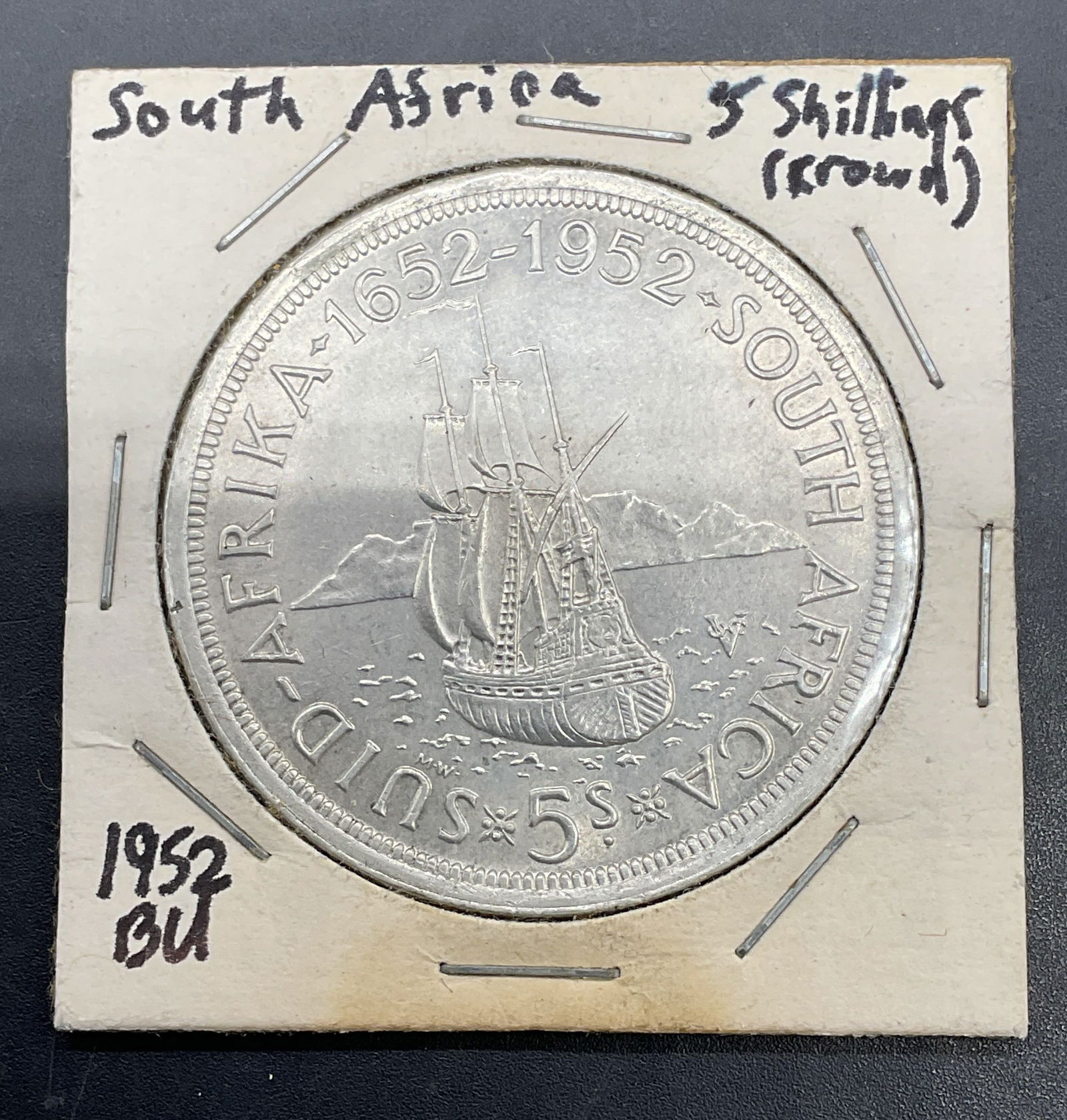 1952 South Africa 5 Shilling Coin, .500 Silver: 1952 South Africa 5 shilling coin. .500 silver. Coin commemorating the 300th anniversary of the first European arrival in South Africa. Reverse features a sailing ship, obverse features bust of King G