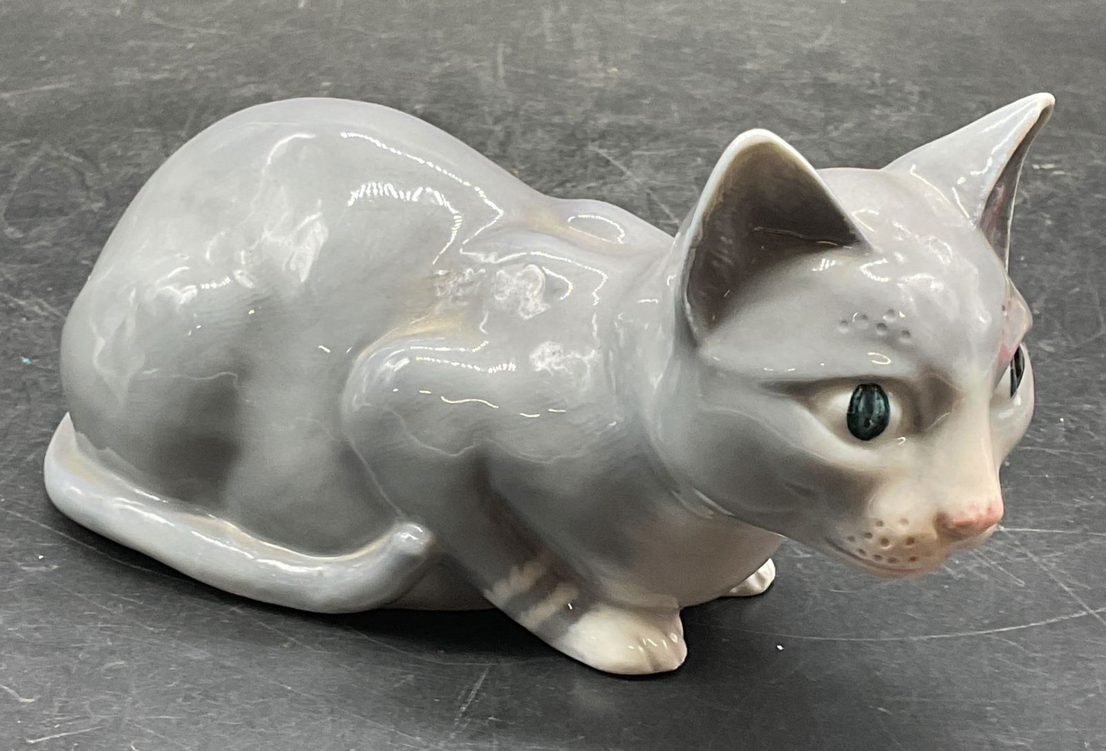 Georg Jensen Gray Cat Porcelain Figurine Portugal: Georg Jensen porcelain cat figurine. Crouching cat. Hand painted gray. Signed. Made in Portugal. Measures approx 6.5 x 3 x 3.25 inches. Some scratching. Georg Jensen figurine, porcelain figurine, cat