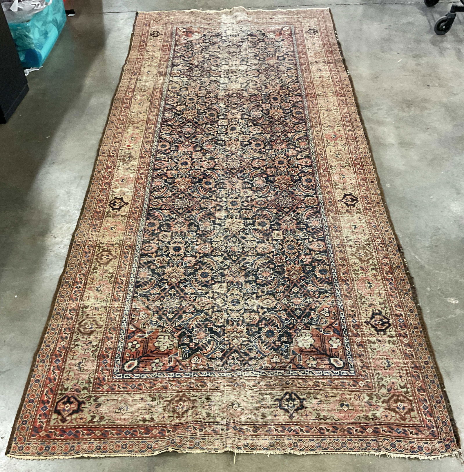 Vintage Handmade Persian Floral Wool Area Rug: Vintage Persian style handmade wool area rug. Intricate geometric floral pattern in blue and red. Measures approx 137 x 59 inches. Wear including fading and some losses. Rug, area rug, vintage rug, Pe