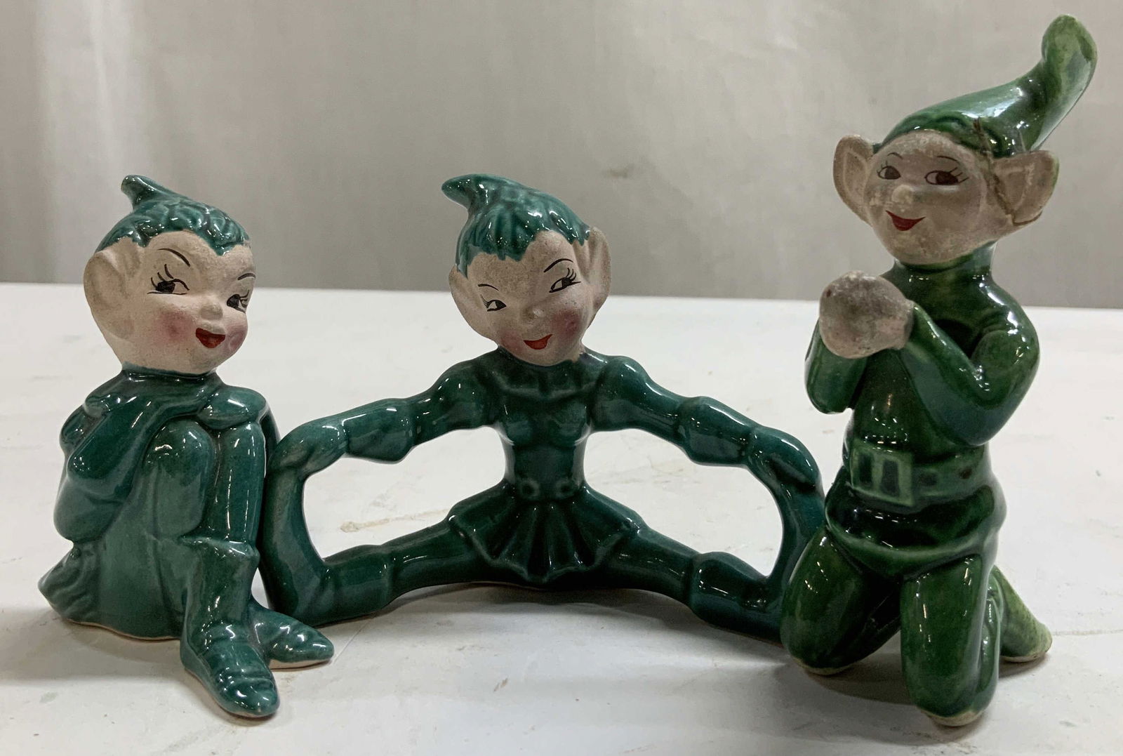 Lot 3 Vtg Whimsical Pixie Elf Ceramic Figurines: Figurines depict 3 pixie elves in various poses. Figs are kneeling, stretching & with its knees pulled up. Shades of green/blue. Property of opera singers estate from the renowned & opulent Manhattan