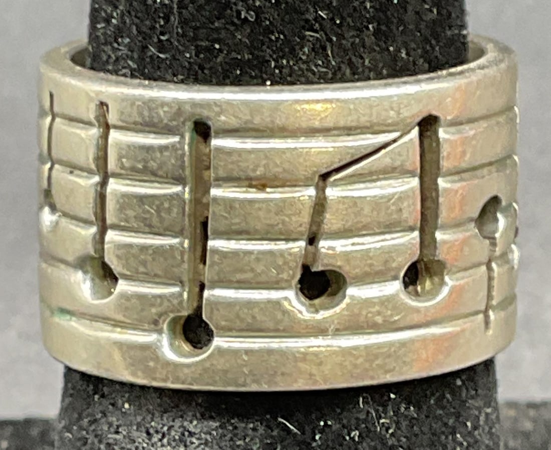 Sterling Silver Music Notes Ring, Mexico: Sterling silver ring with cut out sheet music music note motif. Made in Mexico. Marked sterling. Ring size 6. Total weight 8.6 grams. Some scratching. Jewelry, estate jewelry, fine jewelry, cocktail j