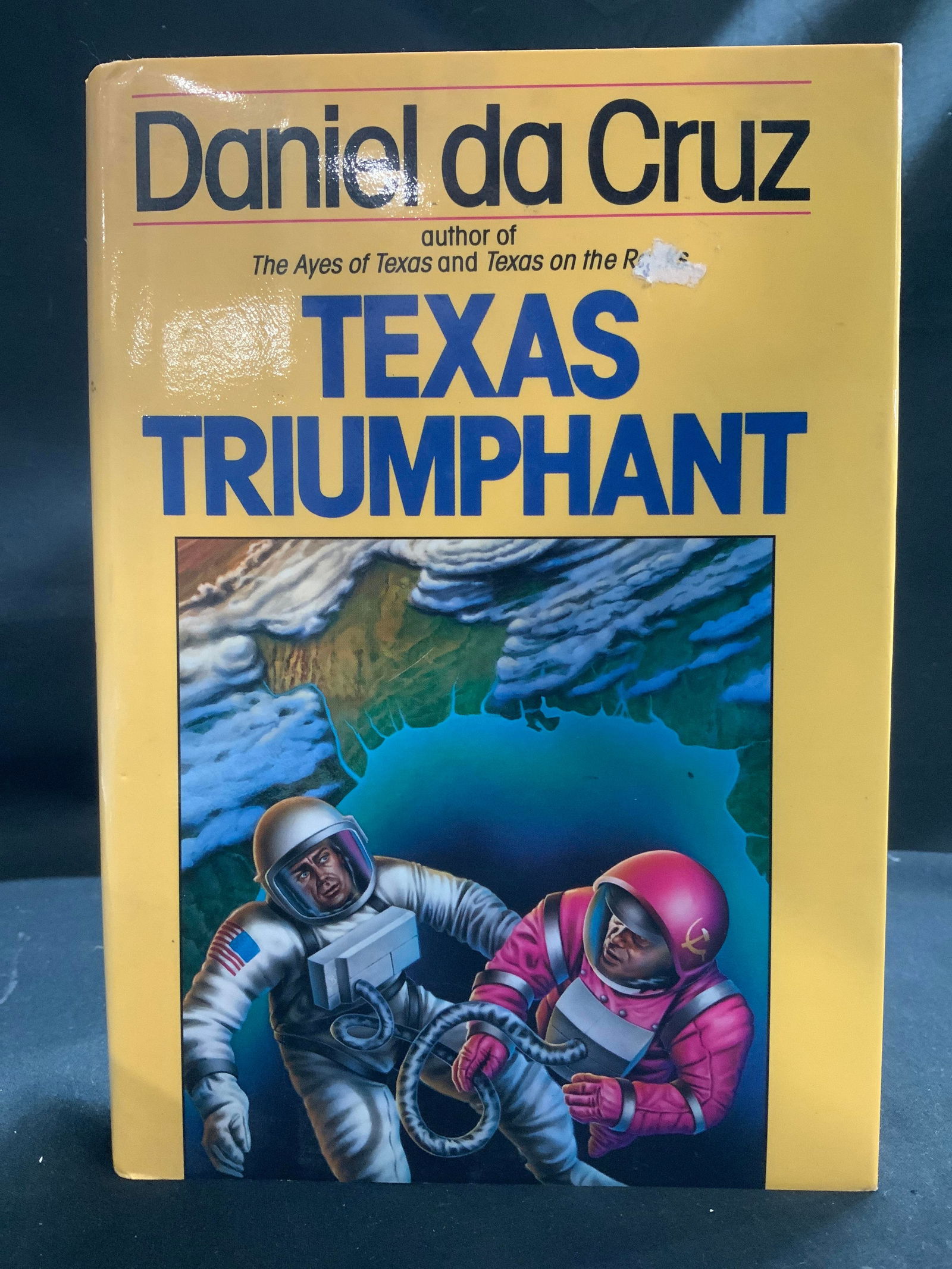 1987 Texas Triumphant 1st Edition Book CRUZ: Texas Triumphant by Daniel da Cruz. Author of The Ayes of Texas & Texas on the Rocks. A Del Rey Book. Copyright 1987. First Edition. Front cover features illustrations of men wearing space gear.