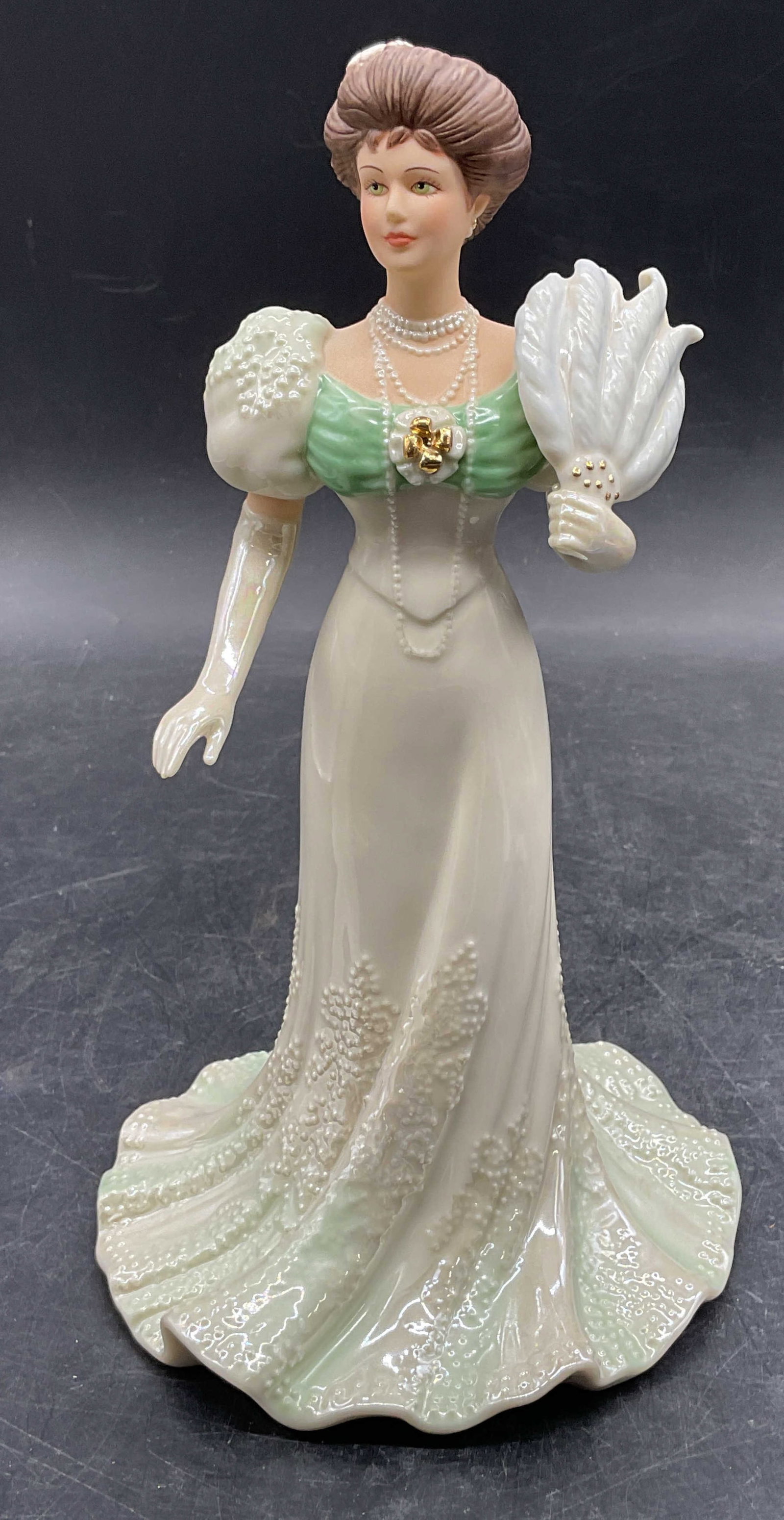 Lenox Centennial Ball Fine China Figurine: Lenox Centennial Ball fine china figurine. Victorian Ladies of Fashion. Hand painted with gilt decoration. Measures approx 4.5 x 8.5 inches. Some wear consistent with exposure. Lenox figurine, Victori
