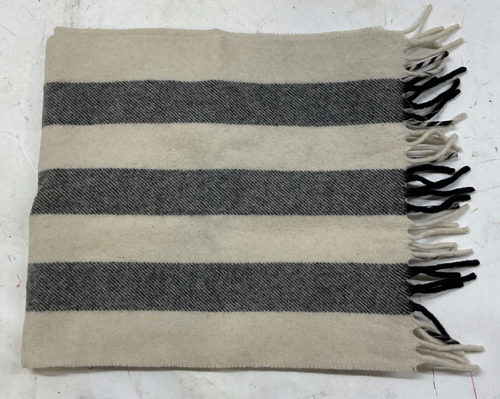Vintage Black & White Striped Fringed Scarf: Vintage black and white striped fringed scarf. Feels like wool. Thick black stripes on white background. Black, white, and twist fringed trim. Measures approx 10 inches wide 50 inches long. Wear
