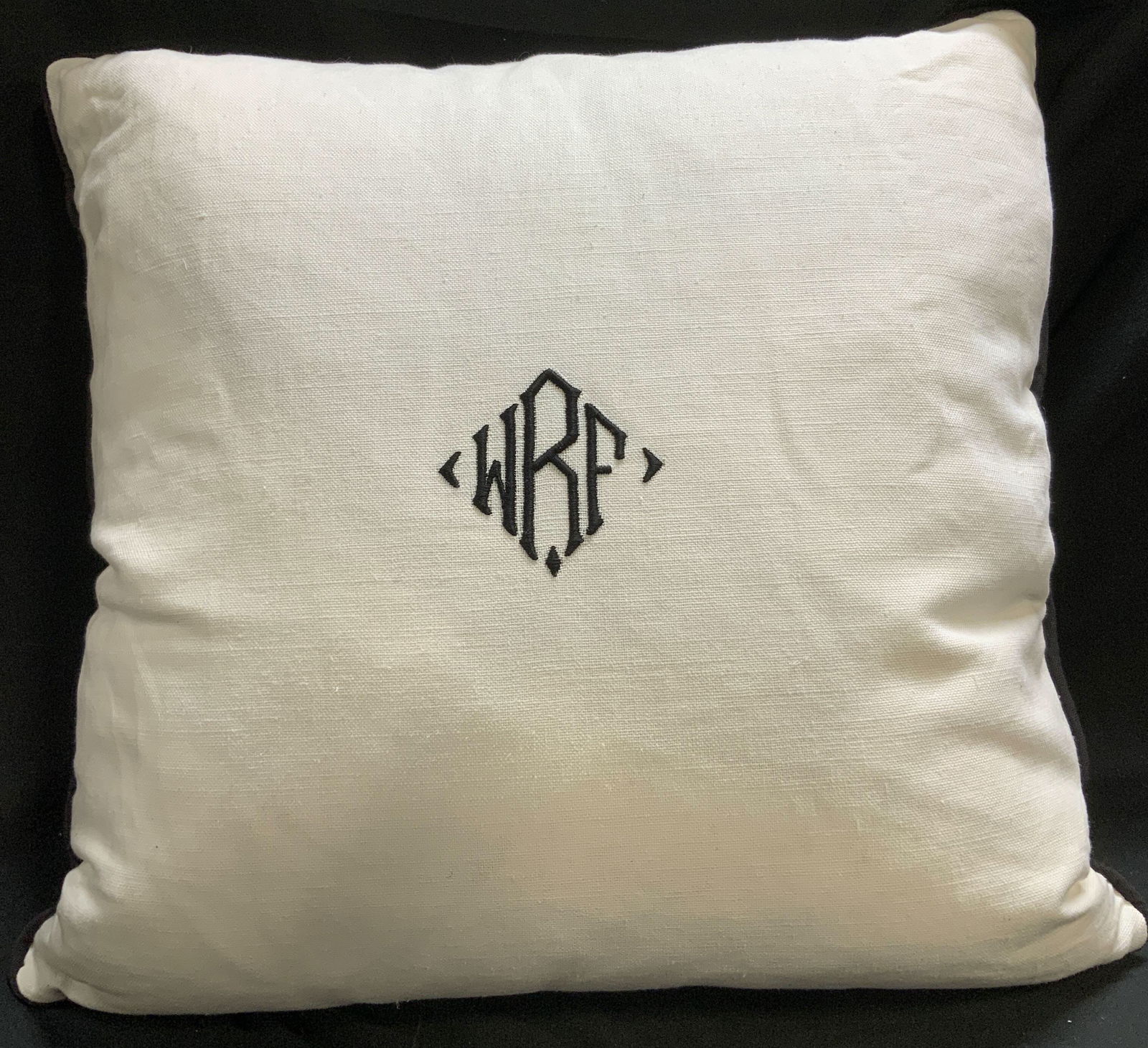 White & Black Monogram WRF Throw Pillow: Square white throw pillow featuring a centered black embroidered monogram WRF. Black edges. Surface wear consistent to age, use & exposure. No visible signature or markings. Measurements: