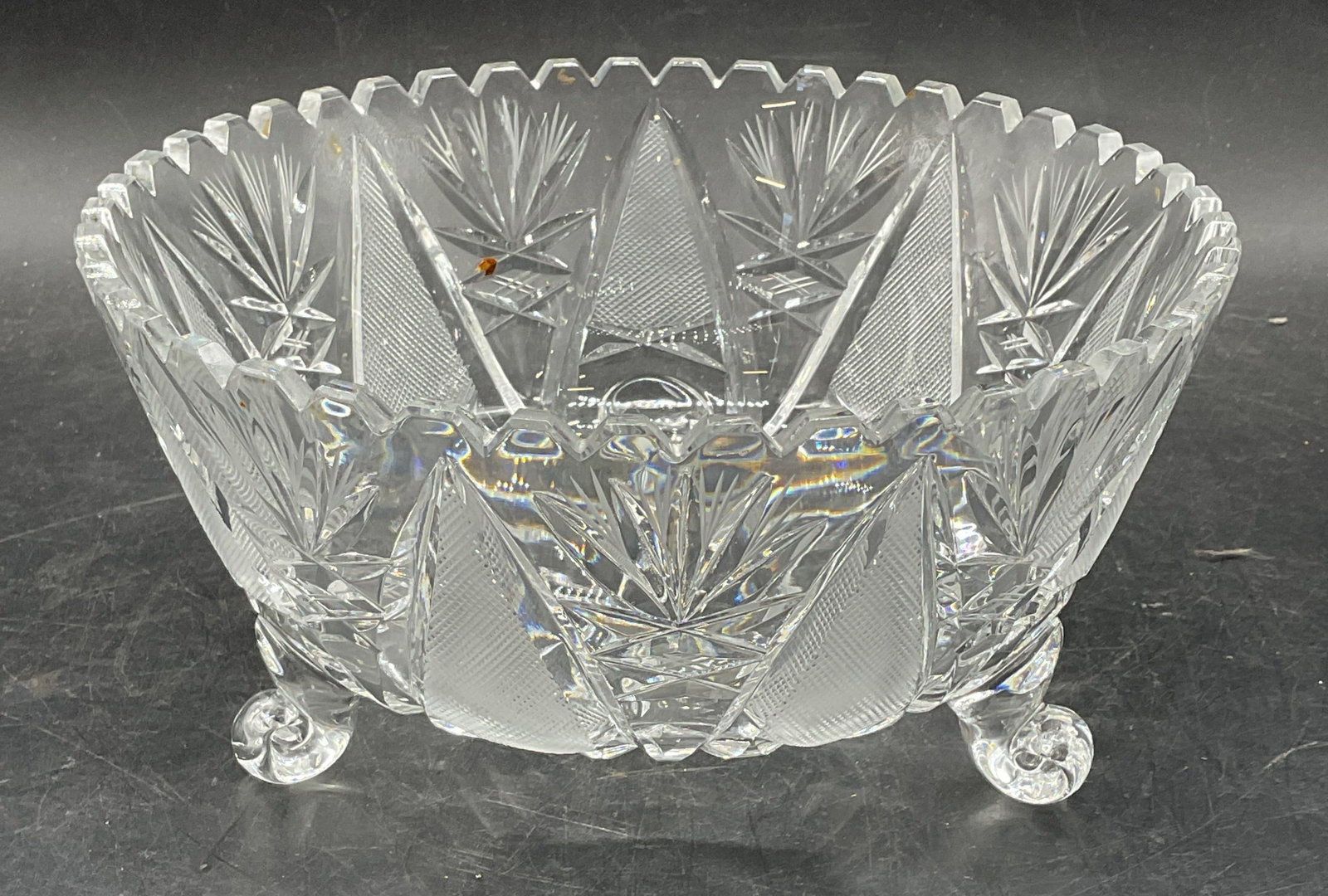 Vintage Cut Crystal Footed Fan Bowl: Vintage cut crystal bowl with sawtooth rim and footed base. Intricate geometric and fan designs. Measures approx 8.25 x 4 inches. Thick walled crystal, piece has weight. Some scratching. Cut crystal b