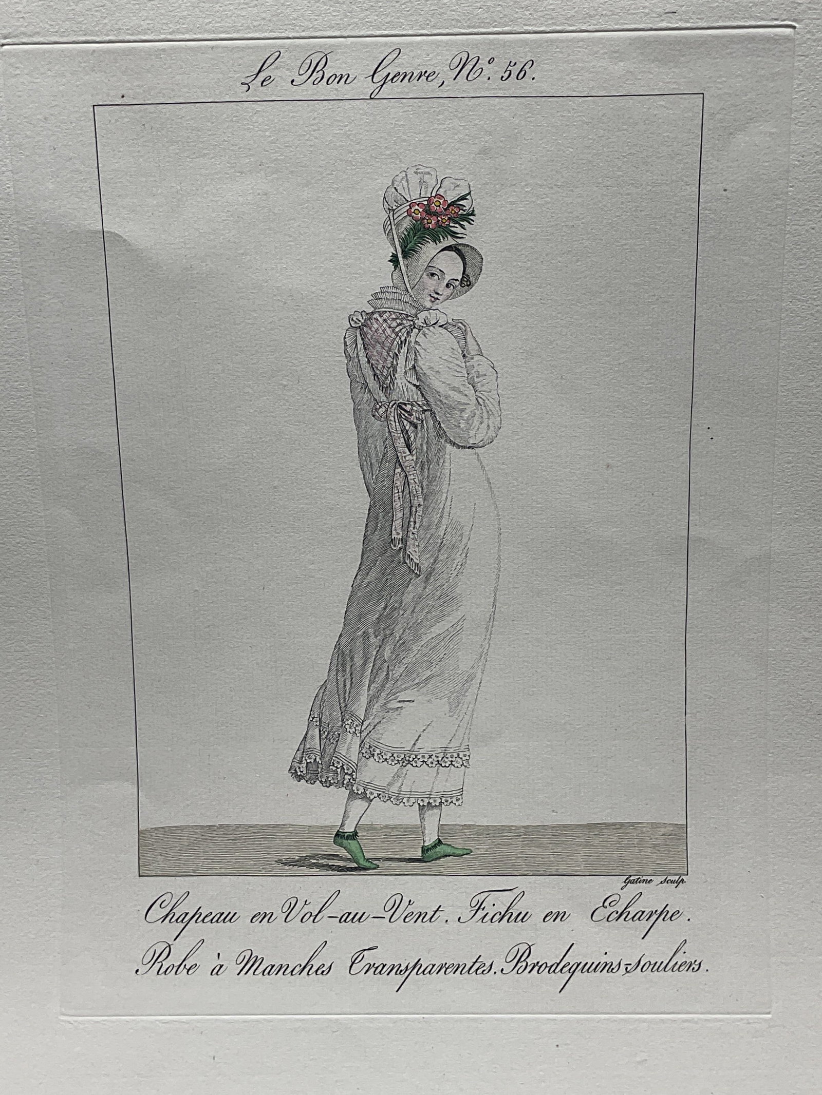 Antq Le Bon Genre Fashion Engraving: Hand colored engraving on paper. From Le Bon Genre, no. 56. French satirical fashion print. Woman wearing bonnet and gown. Published circa early 19th century. Paper measures approx 15.75 x 11.75 inche