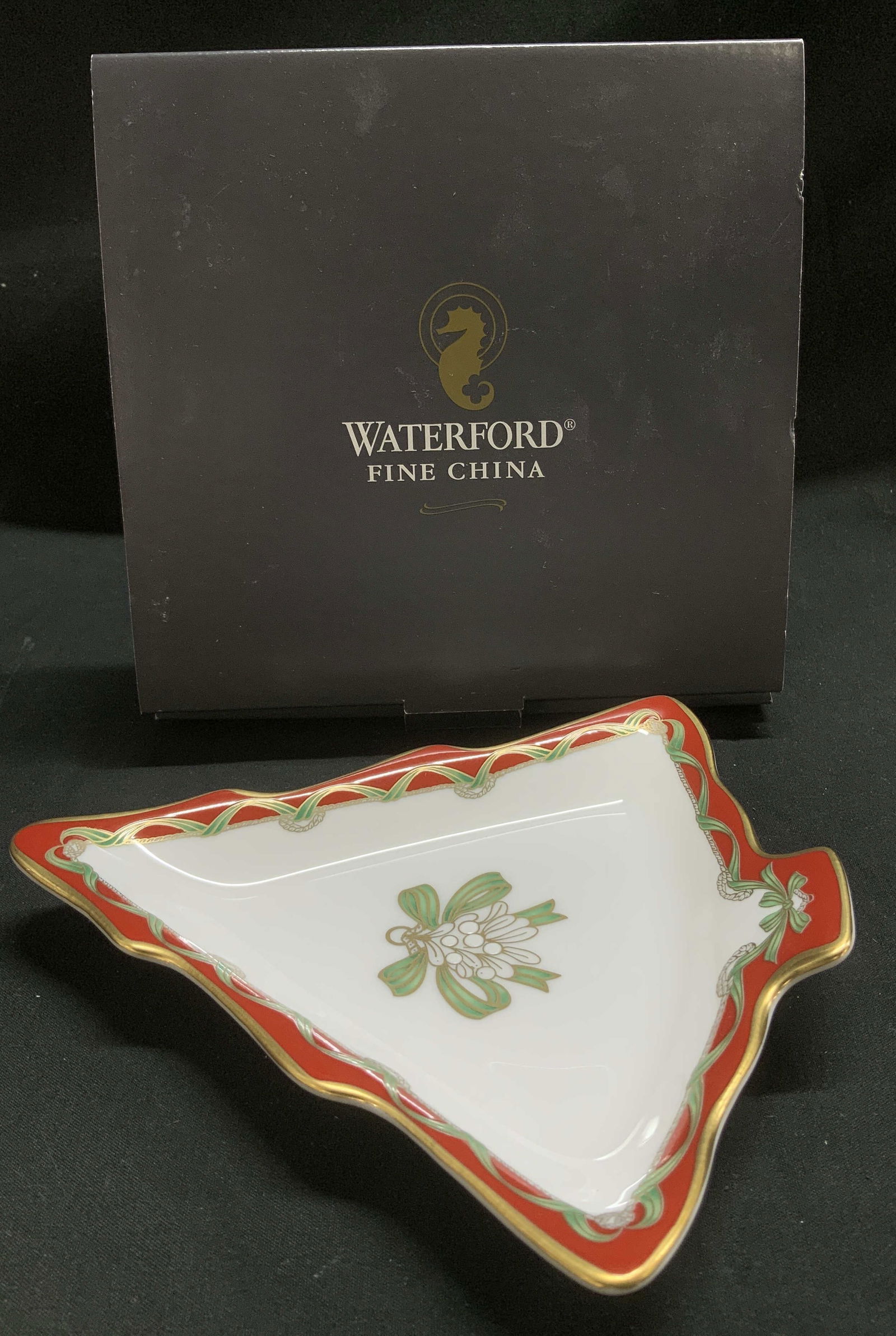 Waterford China Holiday Ribbons Dish JAPAN NIB: Waterford holiday ribbons dish is made of fine china material & is shaped like a tree. Gilt accents on rim. Green ribbons accent in center. Comes with original box. Signed & marked. Reads, WATERFORD F