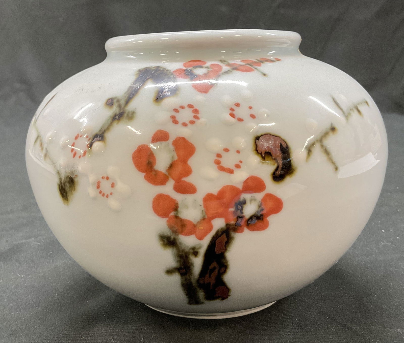 Vintage Hand Painted Ceramic Floral Vase: Vintage hand painted ceramic floral vase. Bulbous body. Wide short neck with an open mouth. Hand painted floral motifs and branches. Colors include brown, pink, and white. Measures ht approx 5