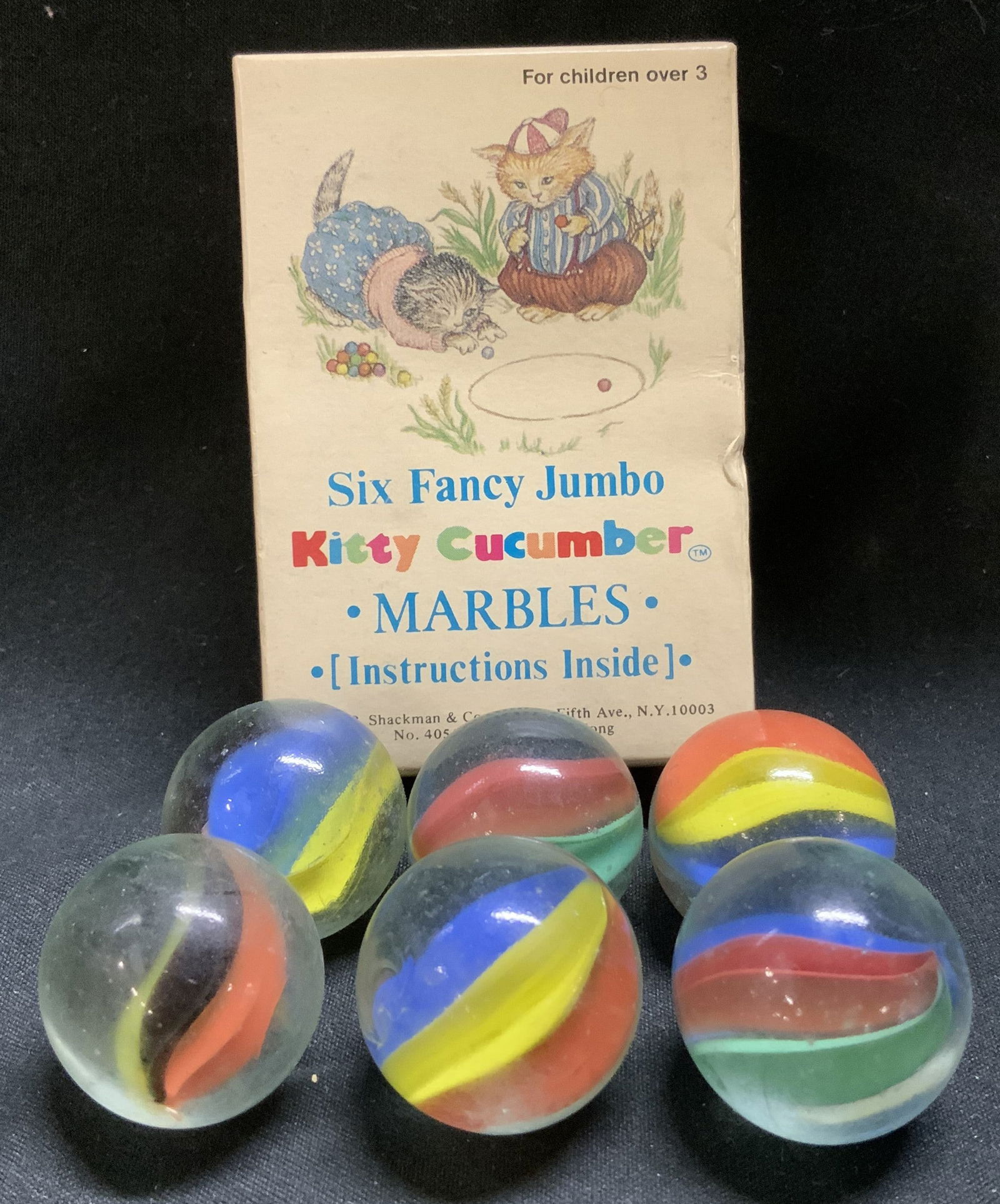1984 B. Shackman&Co. Jumbo Kitty Cucumber Marbles: Vintage B. Shackman & Co., Inc. Six Fancy Jumbo Kitty Cucumber Marbles from 1984. Comes with original box. Lot is sold as is. Property of Upper East Side French stage and screen actors Estate, Manhatt