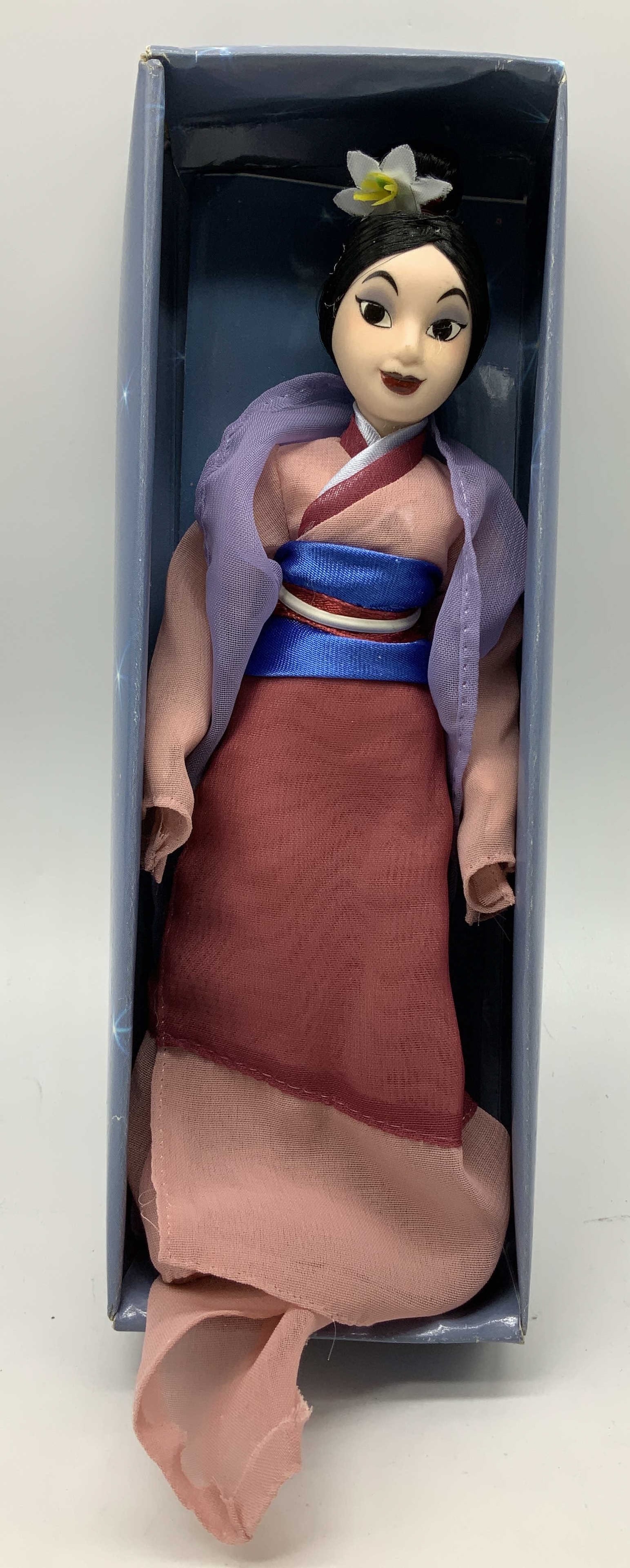 Disney Princess Mulan Porcelain Doll W Box: Disney Princess Mulan doll is wearing a traditional style outfit. Dolls facial features has black eyes & dark red lips. Porcelain material. Comes with packaging box. Signed & marked. Reads,