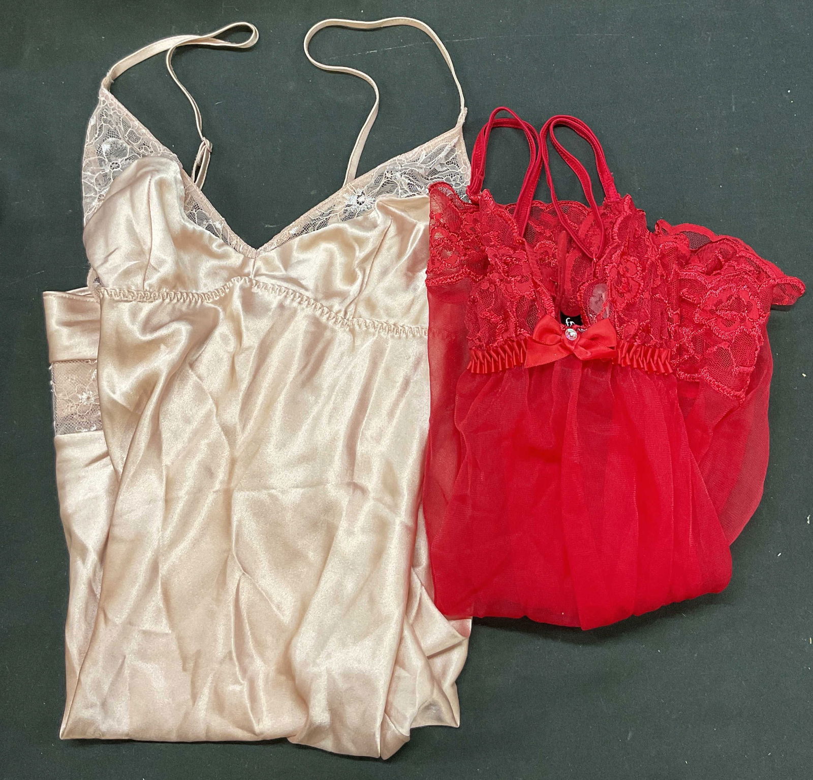 Lot 2 Fredericks Of Hollywood+ Slip Dresses: Lot of 2 items. Fredericks Of Hollywood red lace slip dress. Size Small. Nylon material. Hooks in back. Lace detailing with bow and bead accents. Split seam on one side. Comes with underwear.