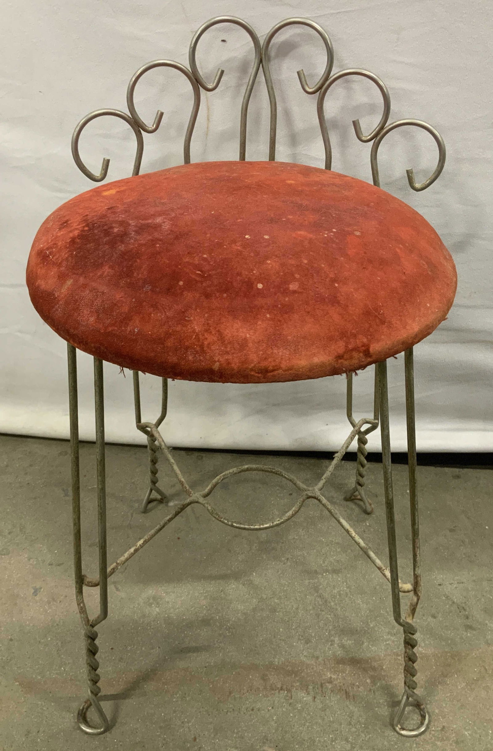 Vtg Hollywood Regency Style Metal Vanity Stool: Vintage Hollywood Regency style metal vanity stool with a red cushioned seat. Twisted wire legs & scroll style backrest. Property of opera singers estate from the renowned & opulent Manhattan