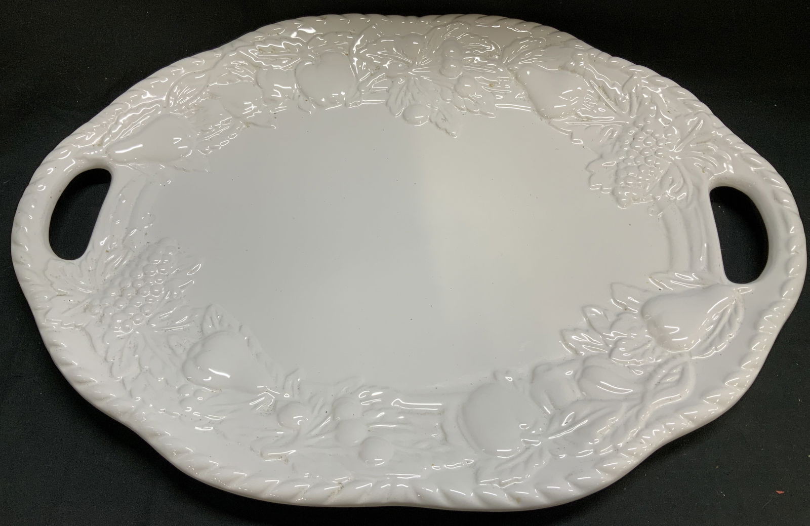 Nature Tabletops Unlimited Embossed Fruit Platter: Nature Tabletops Unlimited large double handled platter with an embossed fruit & leaf pattern. Glossy finish. Signed & marked. Reads, NATURE TABLETOP UNLIMITED CHINA. Surface wear consistent to age, u