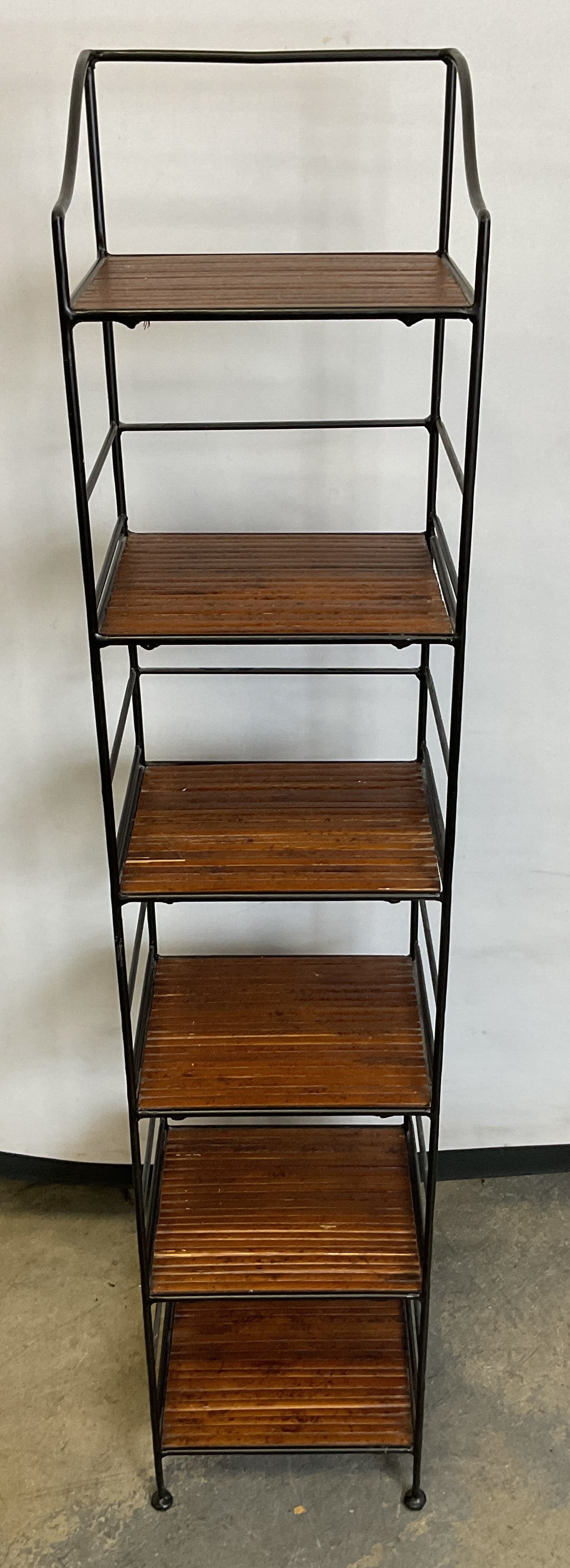 Vintage Wooden & Metal CD Rack 37in: Vintage wooden and metal CD rack. Shelving unit with metal black frame and six wooden shelves. Open frame design. Circular feet with arched frame. Measures approx 7 1/2 x 7 1/2 x 37 inches. Surface we