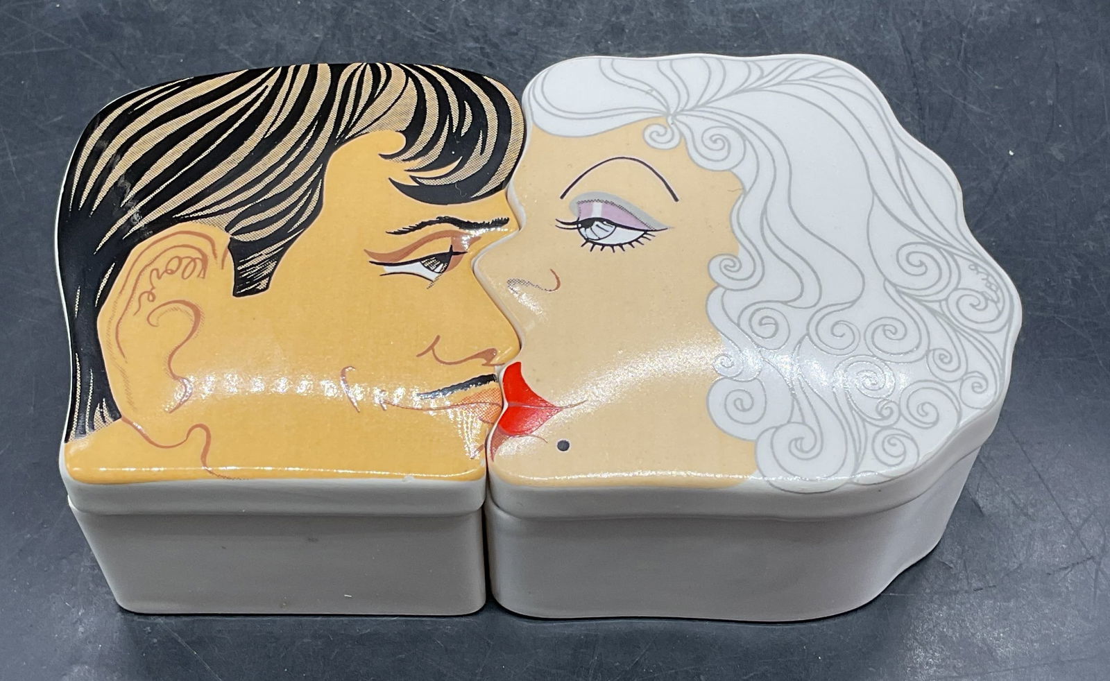 Pair Aldon Gable & Harlow Kissing Trinket Boxes: Pair of vintage 1978 Aldon Accessories Clark Gable and Jean Harlow kissing motif ceramic trinket boxes. Sizes vary. Total dimensions together approx 6.5 x 3.5 x 2 inches. Signed. Some wear consistent