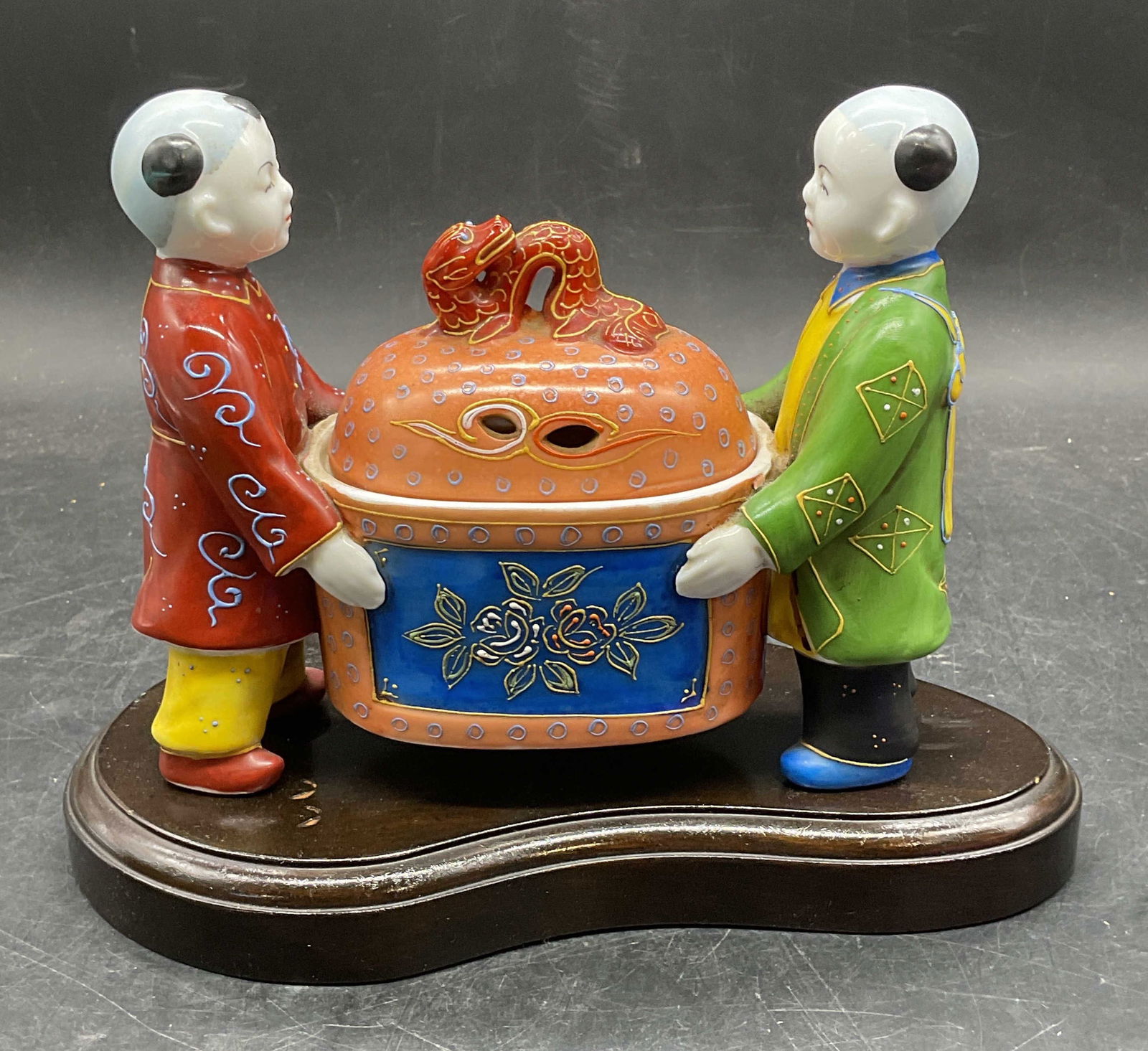 Vtg Japanese Porcelain Figural Incense Burner: Vintage Japanese porcelain incense burner. Two children holding bowl with dragon finial lid. Hand painted. Measures approx 6.75 x 2.5 x 5.75 inches. Includes wood stand. Some wear consistent with