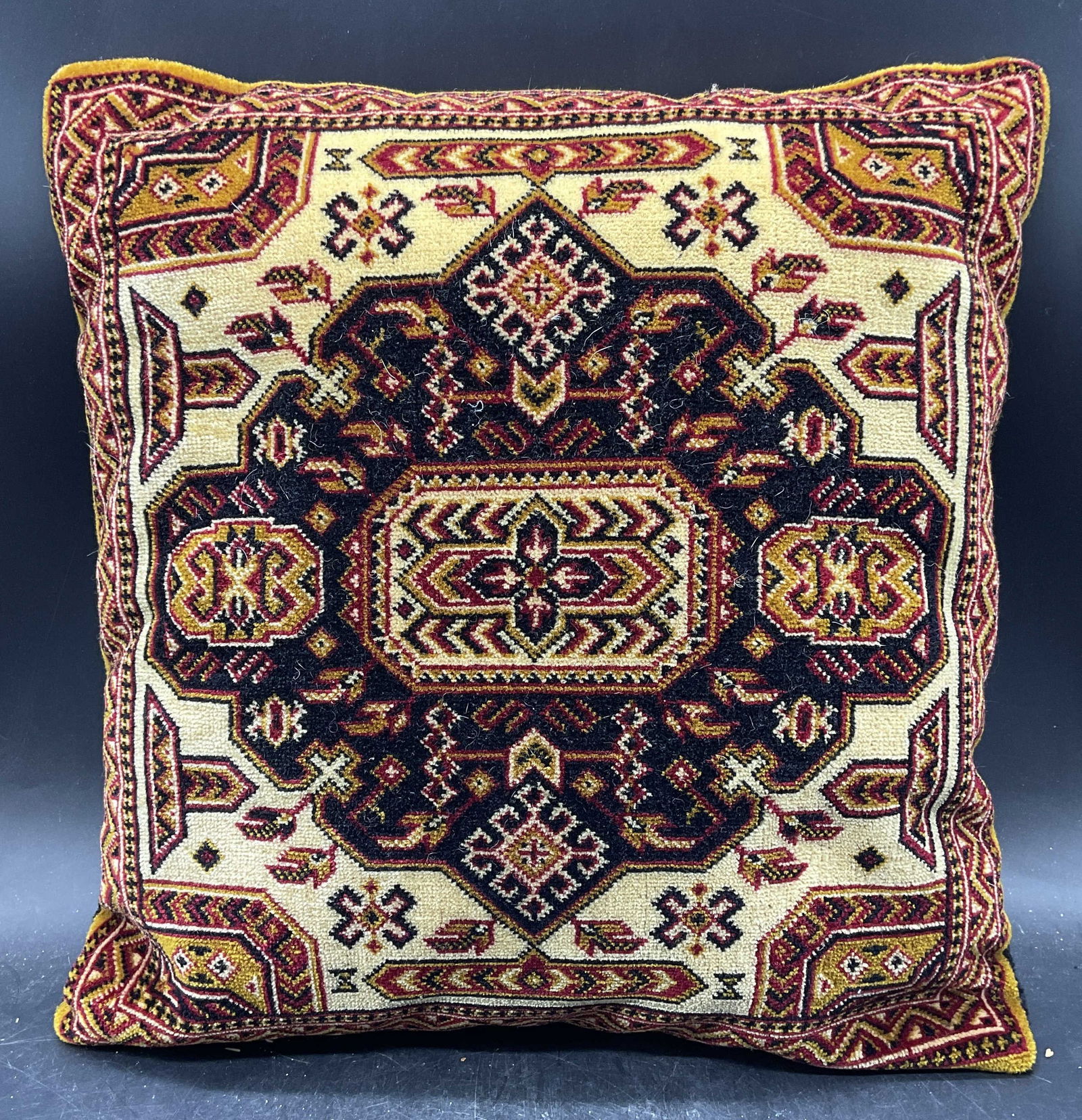 Vtg Persian Style Wool Carpet Pillow, Austria: Vintage handmade Persian style wool carpet throw pillow. Made in Austria. Medallion design with intricate geometric borders in beige and red. Measures approx 16 x 16 inches. Some wear consistent