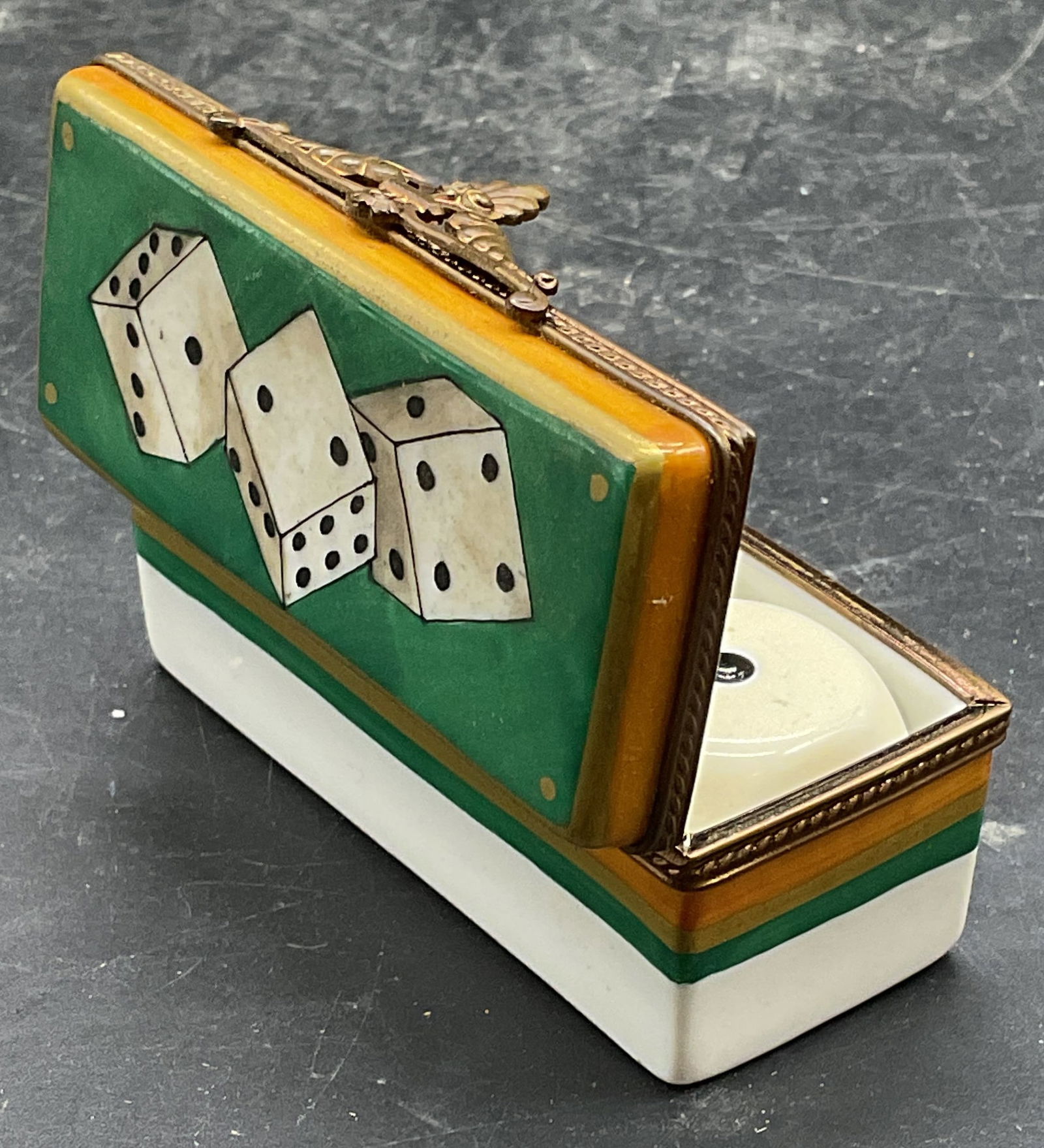 Limoges Porcelain Dice Trinket Box, France: Limoges porcelain dice game trinket box with 3 dice. 421 dice game box. Hand painted dice motif, signed. Made in France. Measures approx 2.75 x 1 x 1.25 inches. Some scratching and loss to pigment. Li