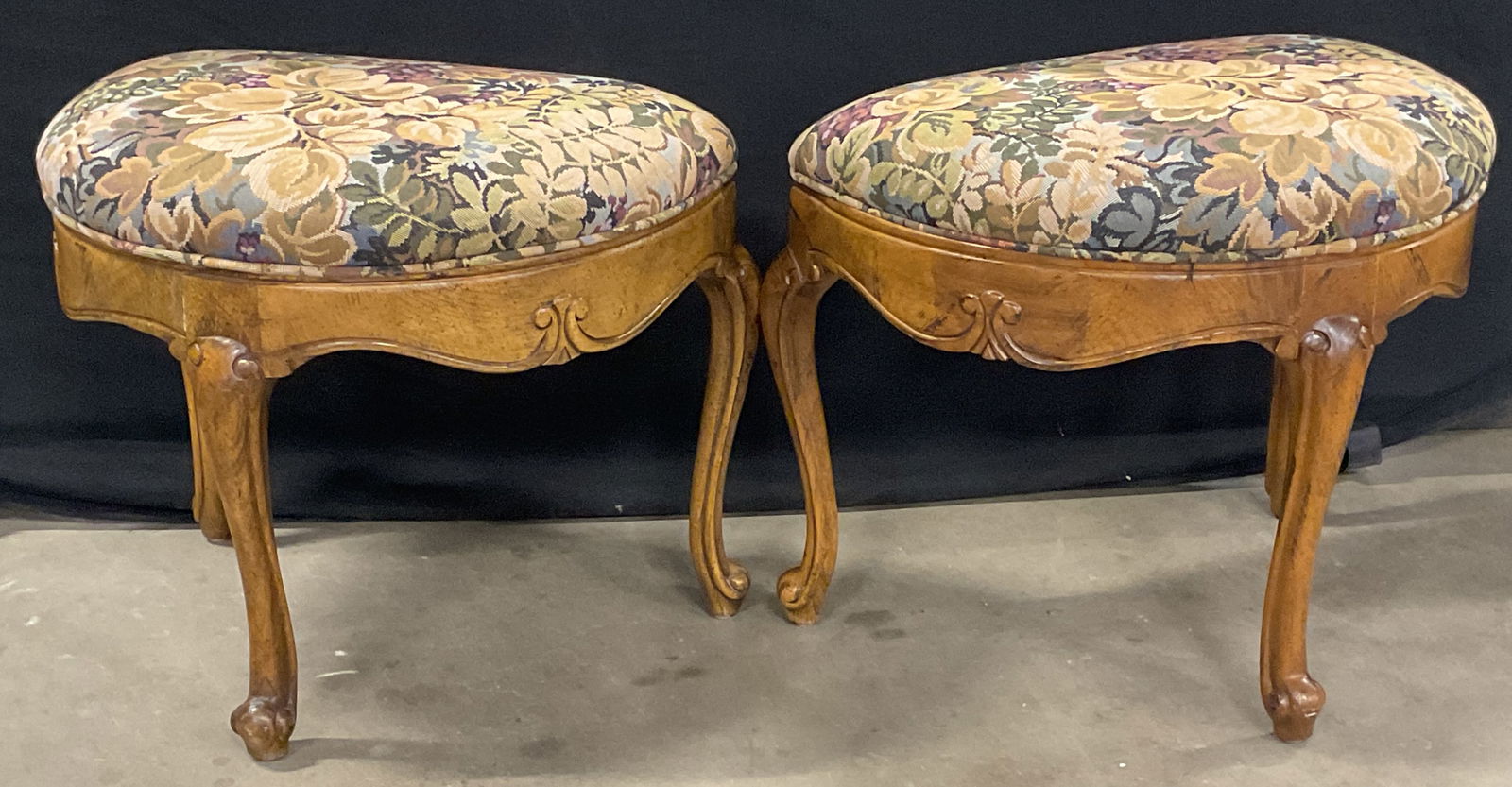 Pair Louis XV Style Upholstered Foot Stools: Pair of Louis XV style foot stools or benches. Demilune shaped frames with carved cabriole legs and claw feet. Floral pattern upholstery. Measure approx 20 x 14 x 16 inches. Some scratching. Louis XV