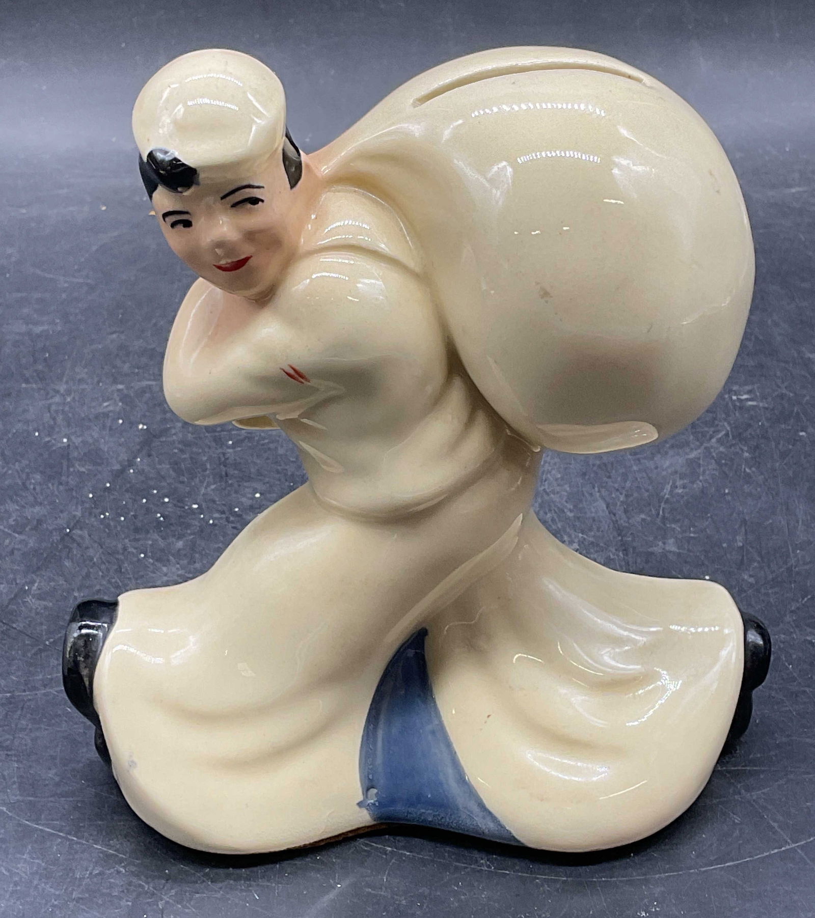 McCoy Seamans Saving Ceramic Coin Bank: McCoy Pottery figural coin bank made for The Seamans Bank For Savings. Sailor carrying sack. Measures approx 5.25 x 3.25 x 5.5 inches. Some wear consistent with exposure. Seamans saving bank, seamans