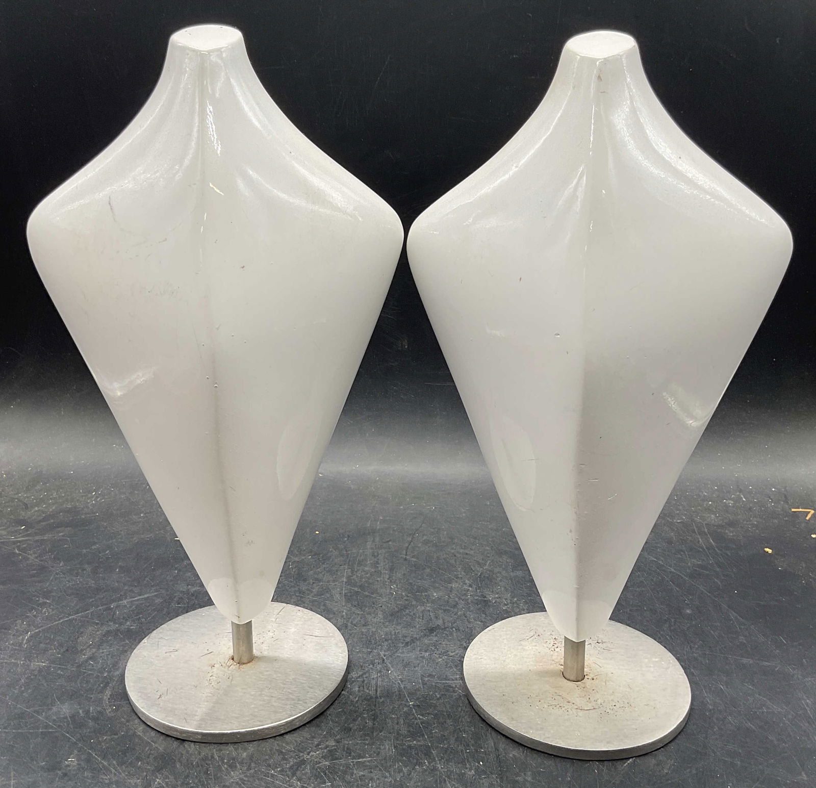 Pair SILVESTRI White Bust Form Decorative Objects: Pair of SILVESTRI white bust form decorative objects or jewelry holders. Enameled white over composite material with heavy metal bases. Signed. Measures approx 6 x 11 inches. Wear including