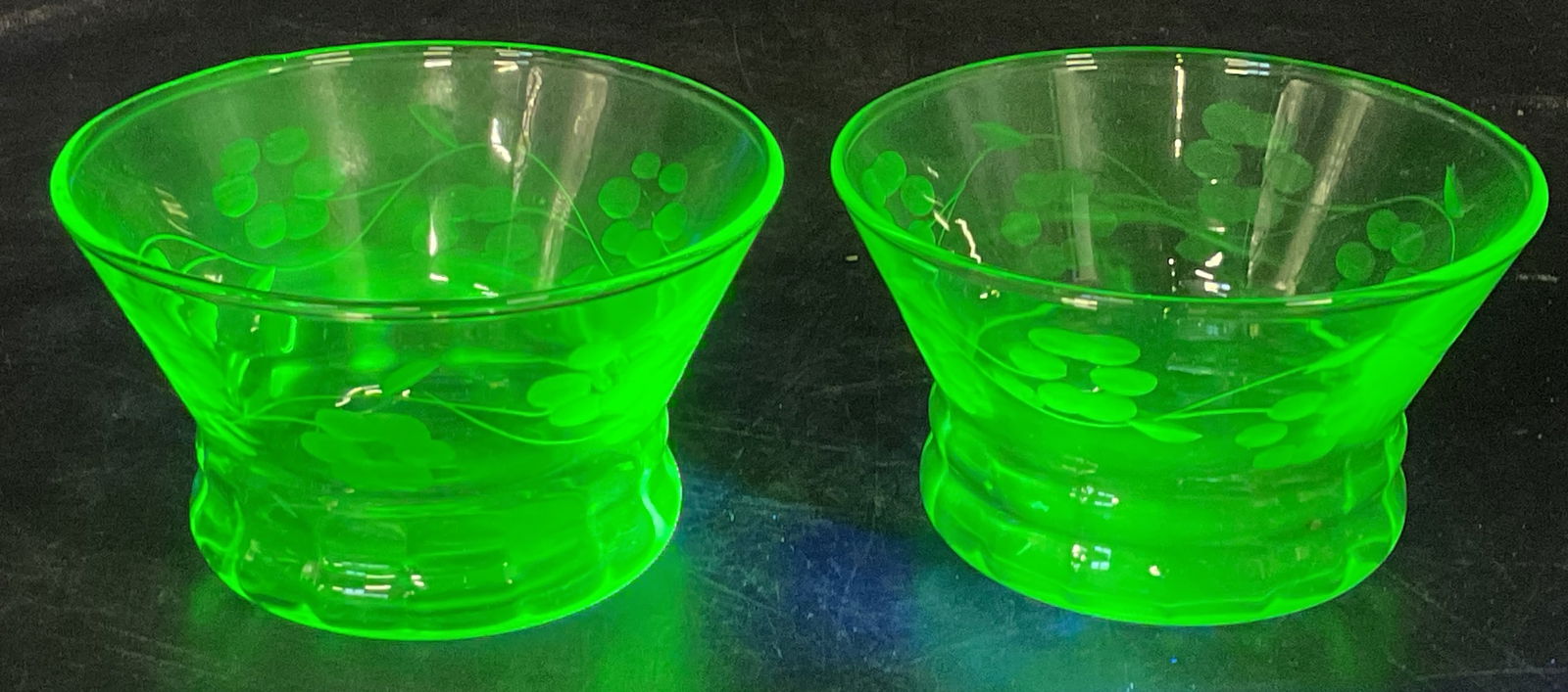 Pair Vtg Uranium Etched Glass Floral Bowls: Pair of vintage uranium etched glass footed bowls. Floral designs. Measure approx 3.5 x 2.25 inches. Glass is UV light reactive. Some scratching. Uranium glass, vintage uranium glass, uranium 